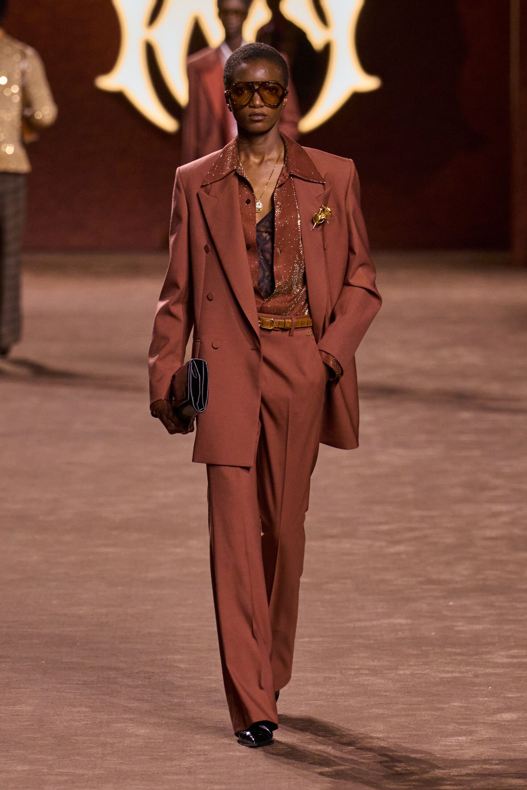 brown tailored suit with sunglasses