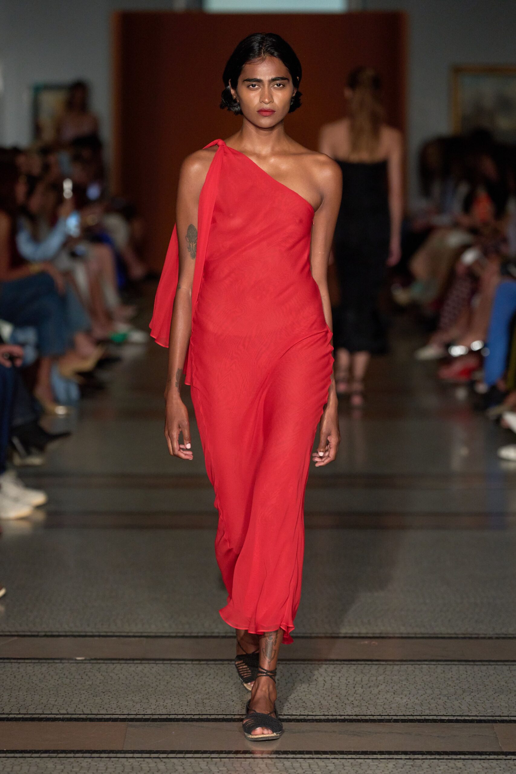 red silk asymmetric gown with strappy shoes