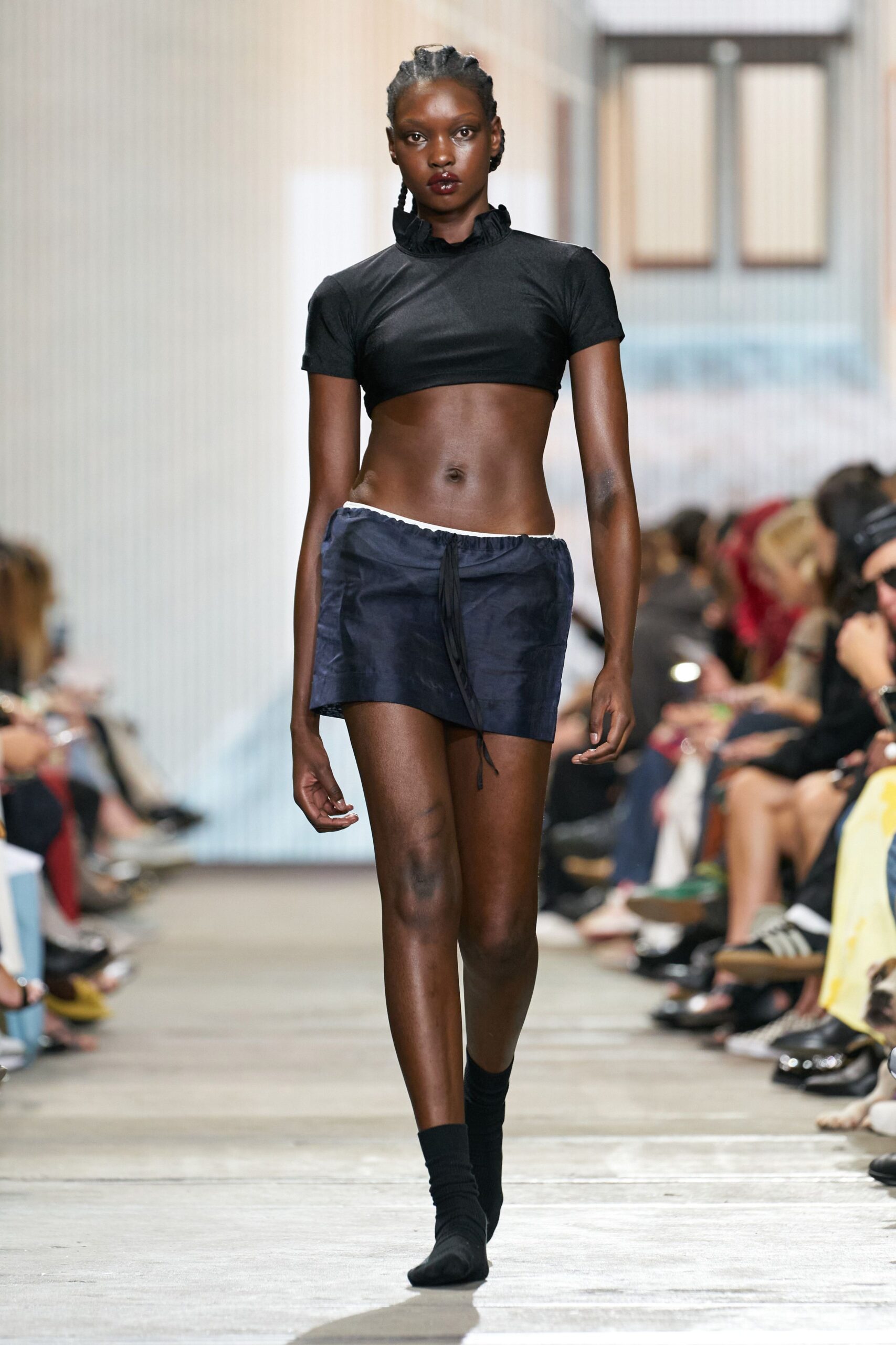 black crop-top and blue mini-skirt