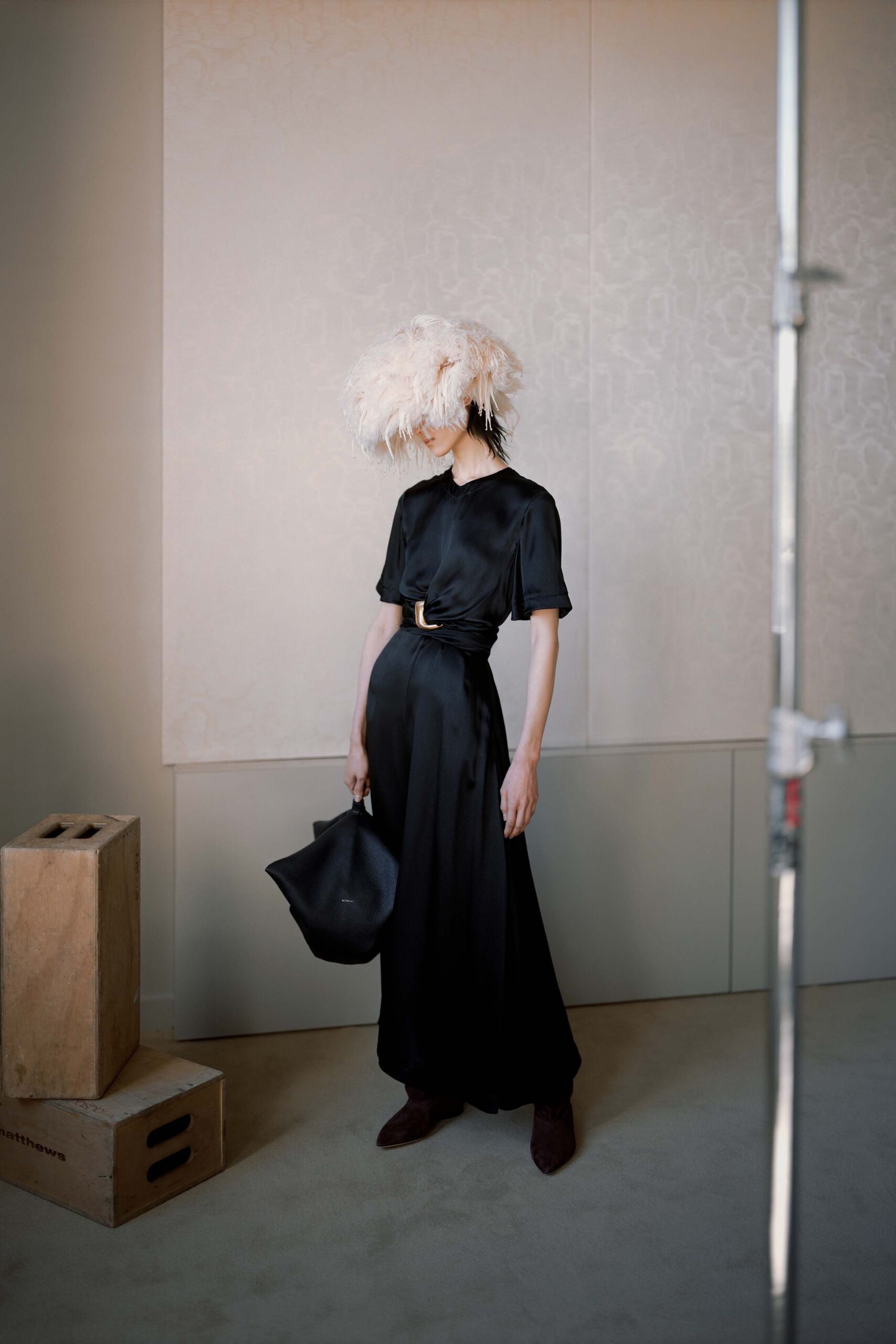 black silk maxi dress with feather hat