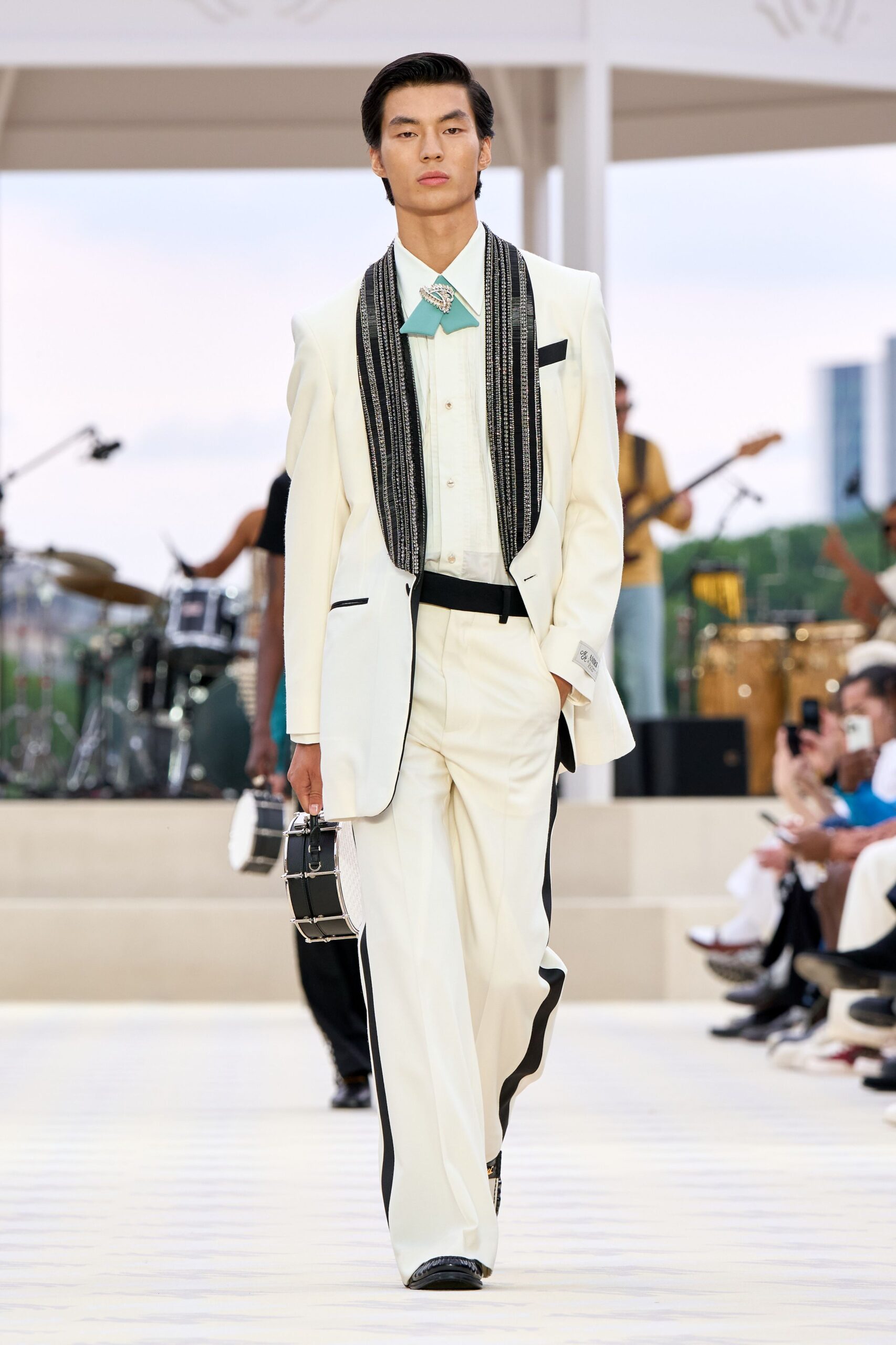 white tailored suit with black scarf