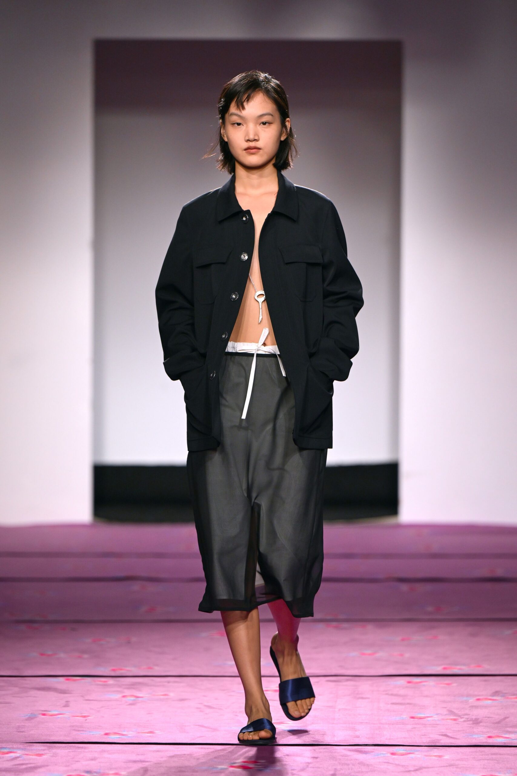 black relaxed jacket gray pants blue shoes