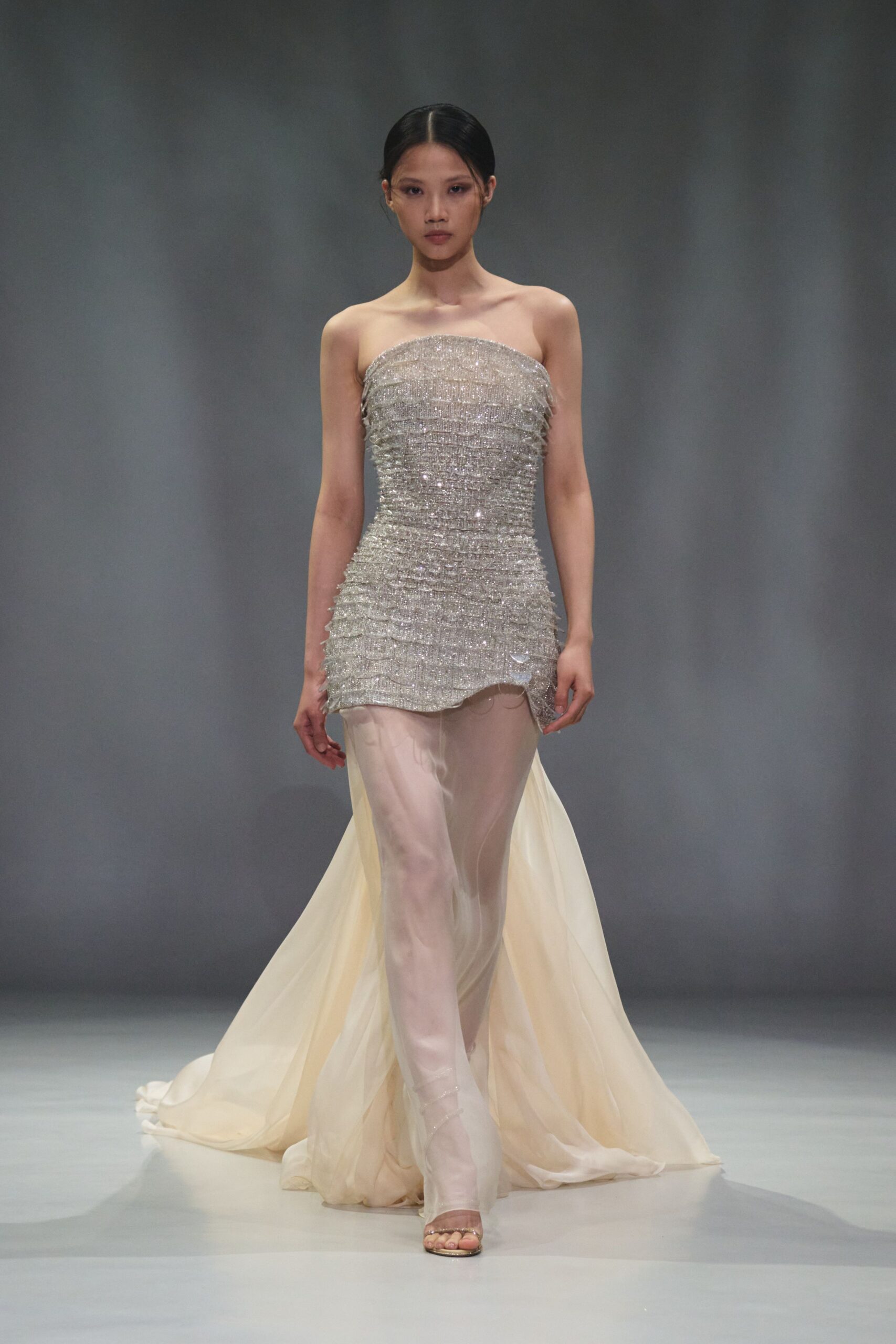 gray sequin strapless fitted layered pleated flowing gown