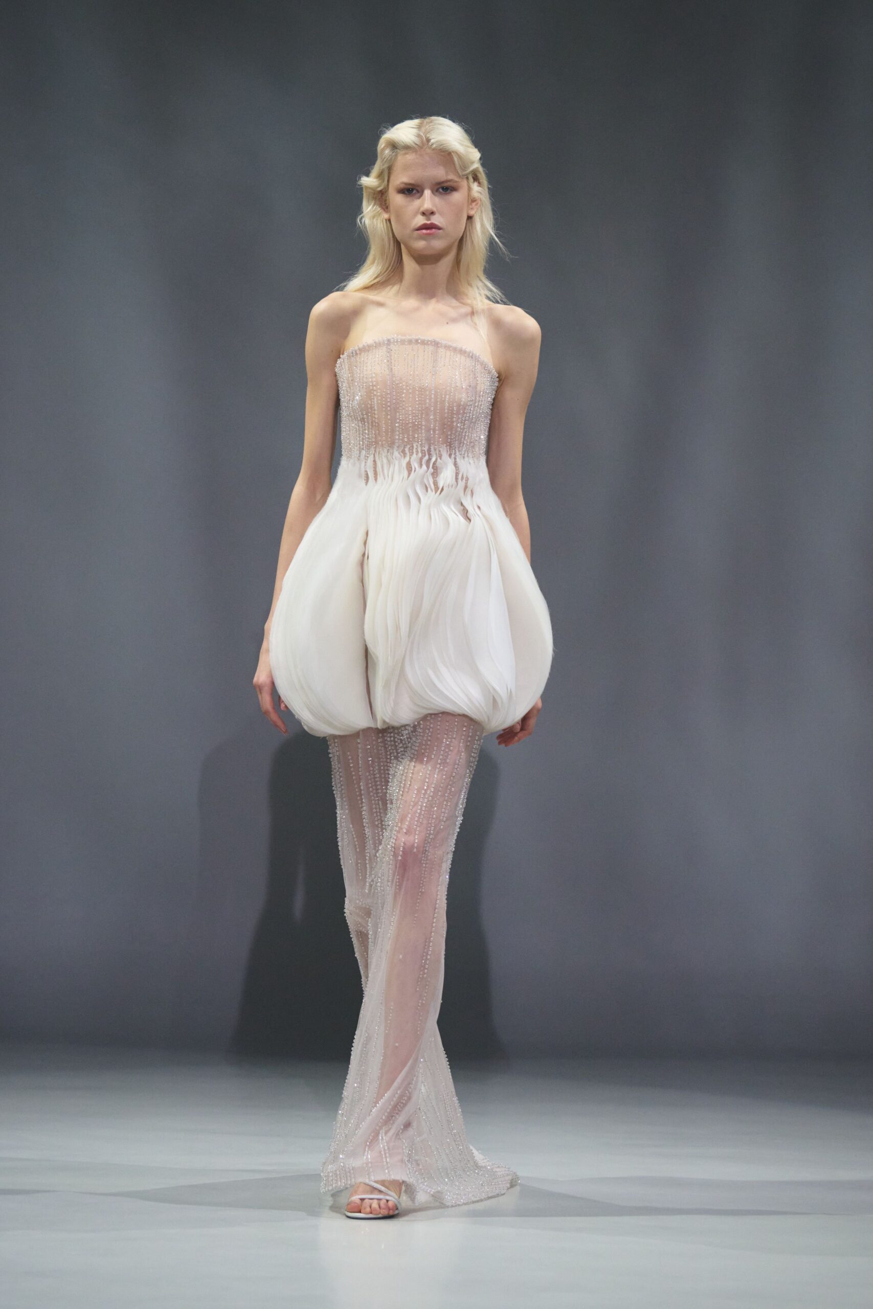 white silk sleeveless strapless fitted pleated layered gown