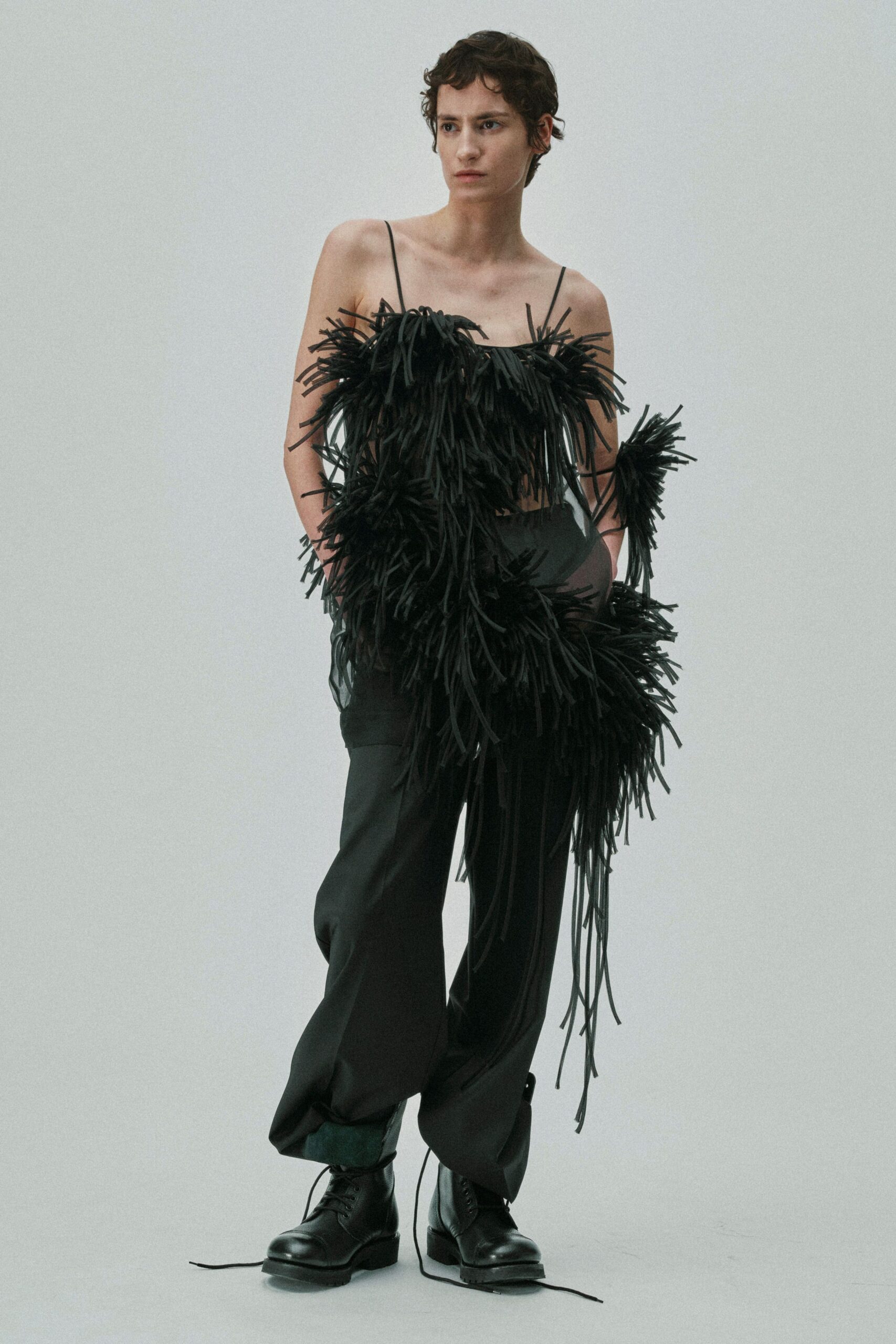 black fringed top with relaxed pants
