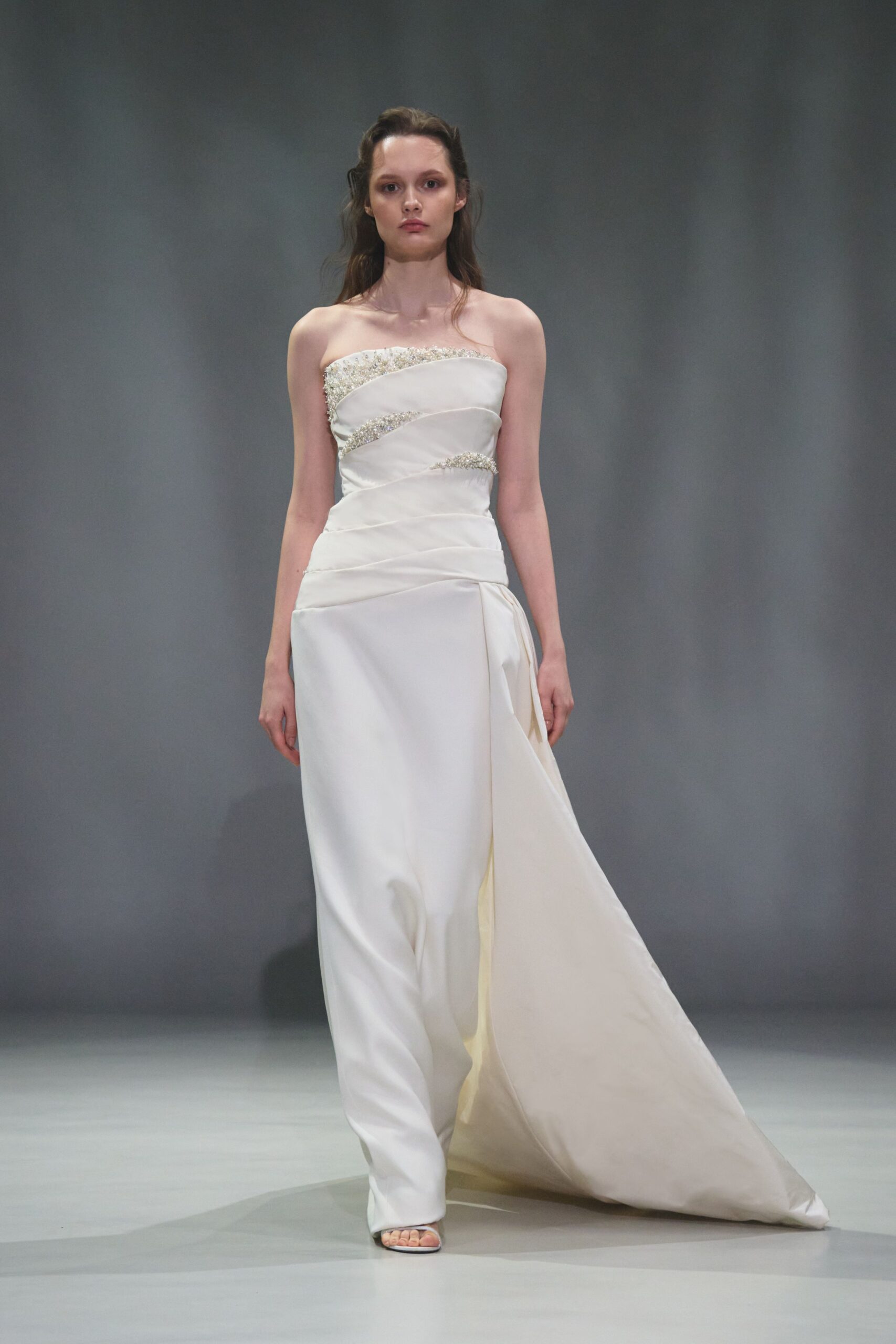 white silk strapless fitted draped embellished flowing gown