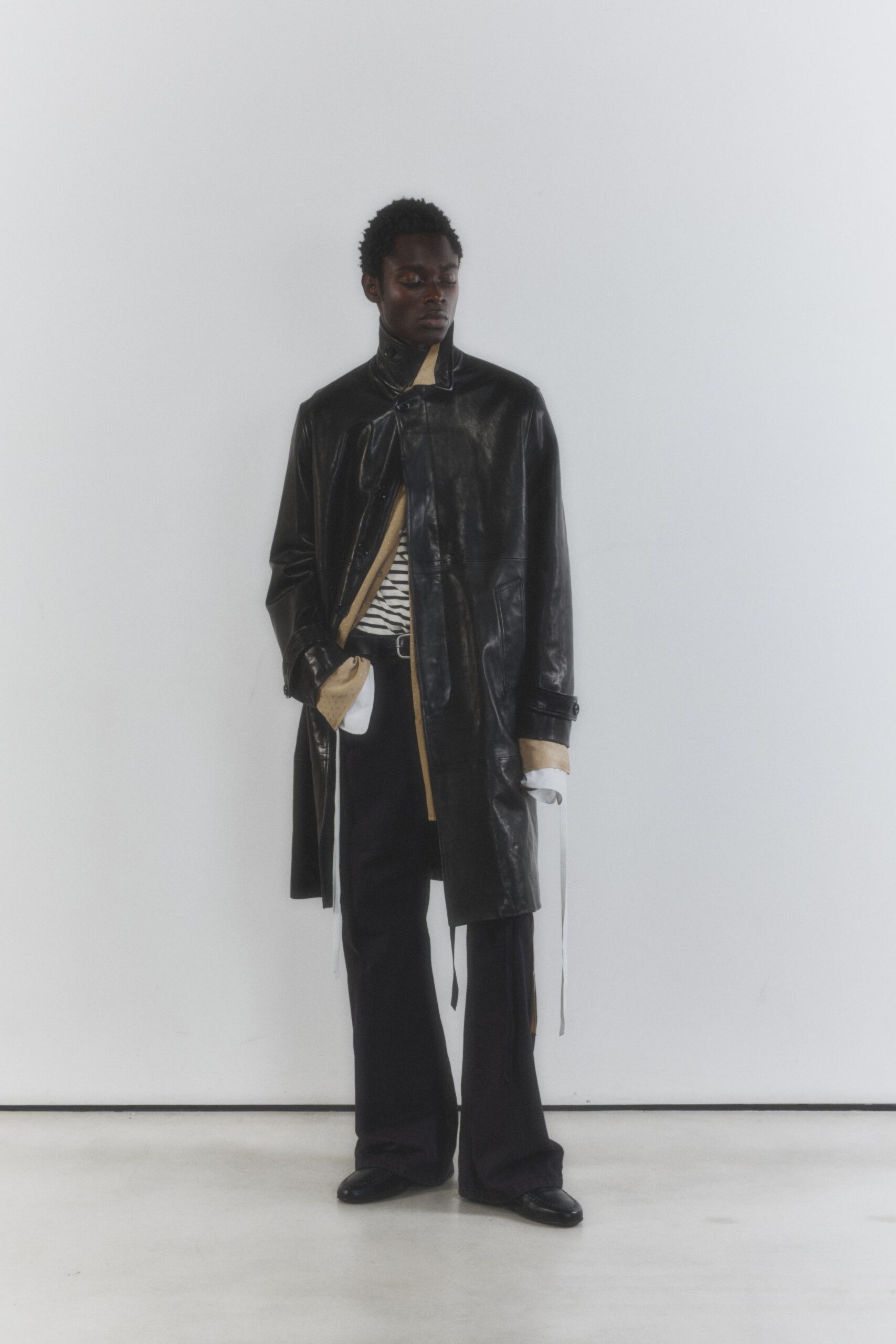 black leather long-sleeve collared oversized buttoned layered coat