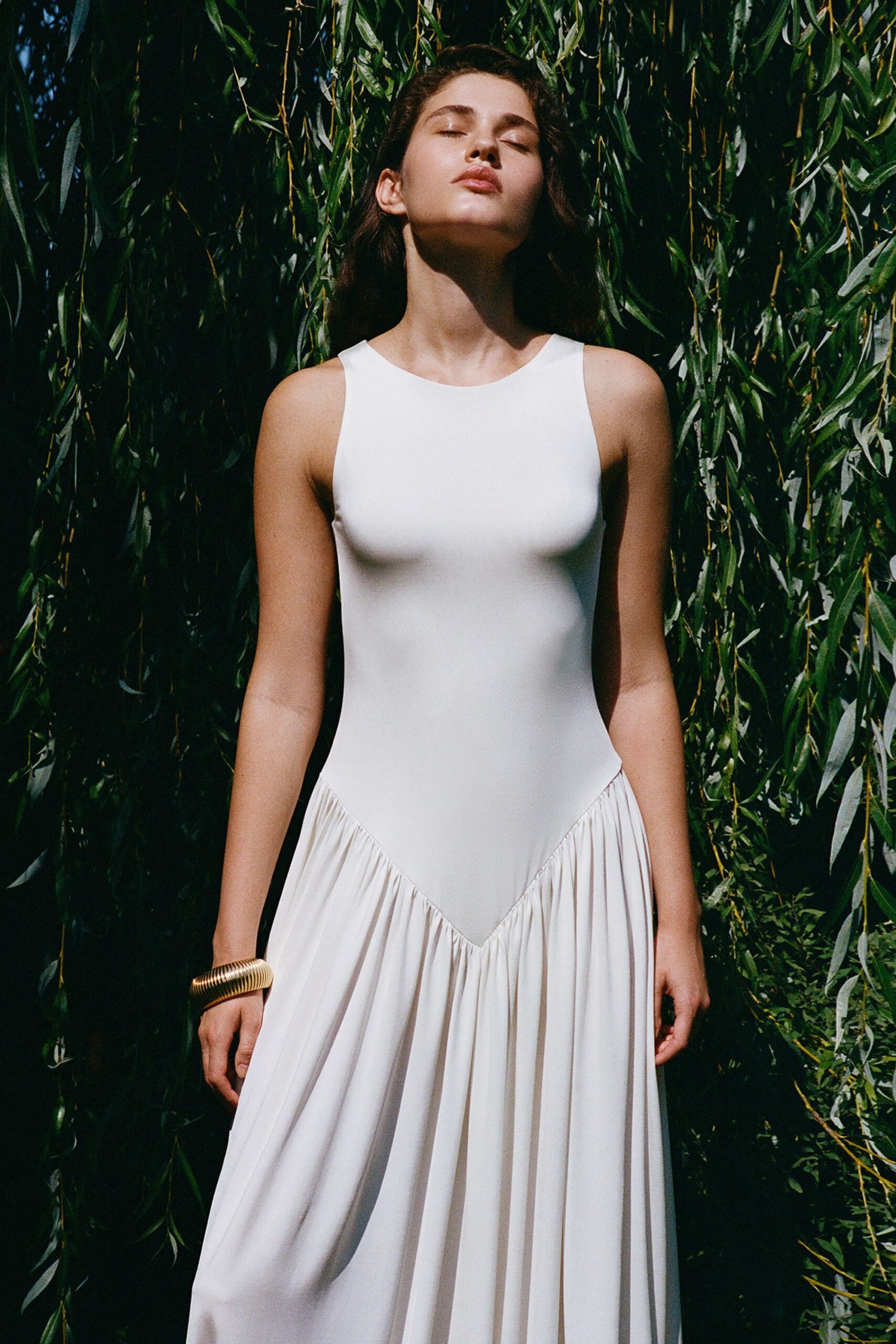 white pleated sleeveless dress