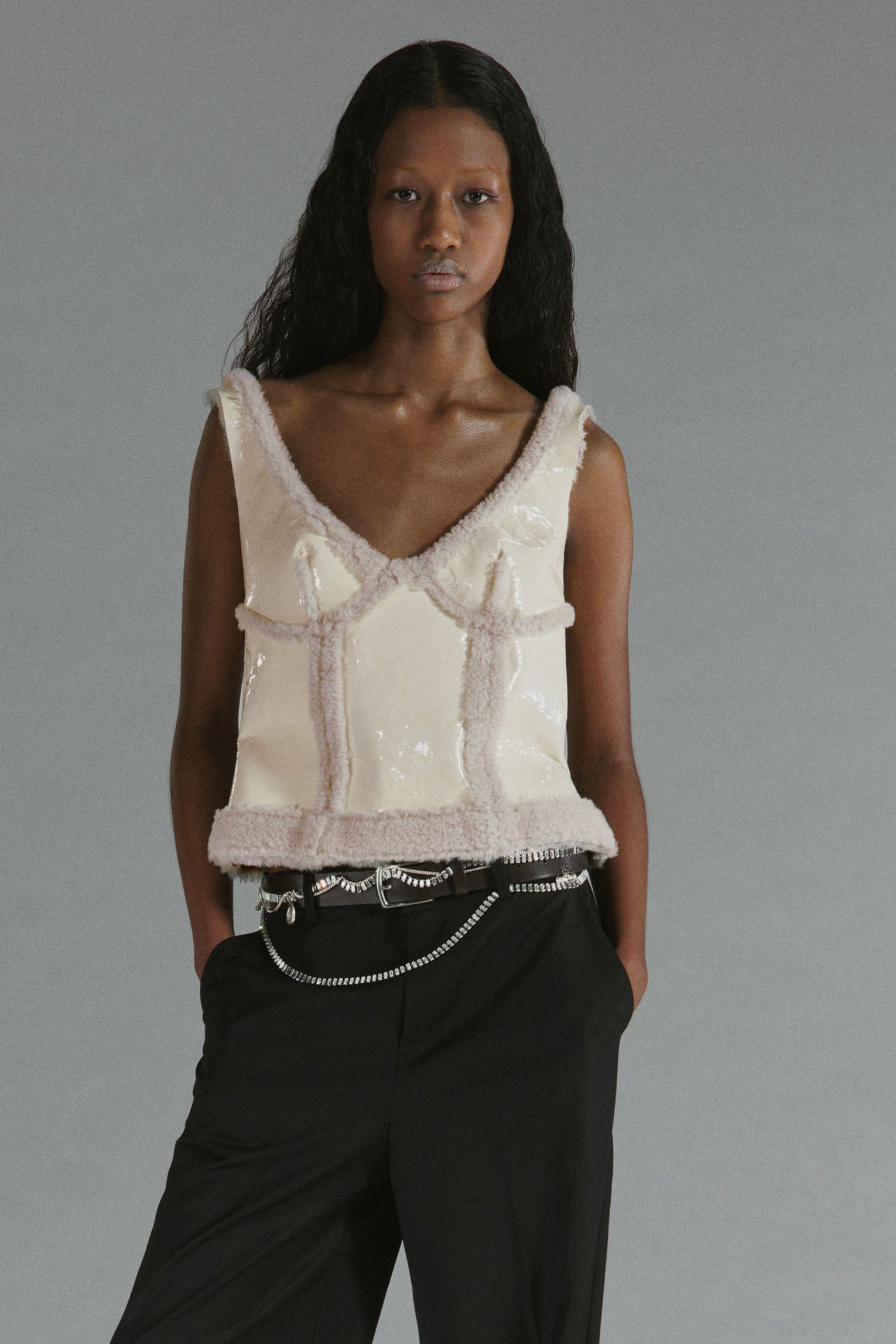 pink silk fitted top with black pants