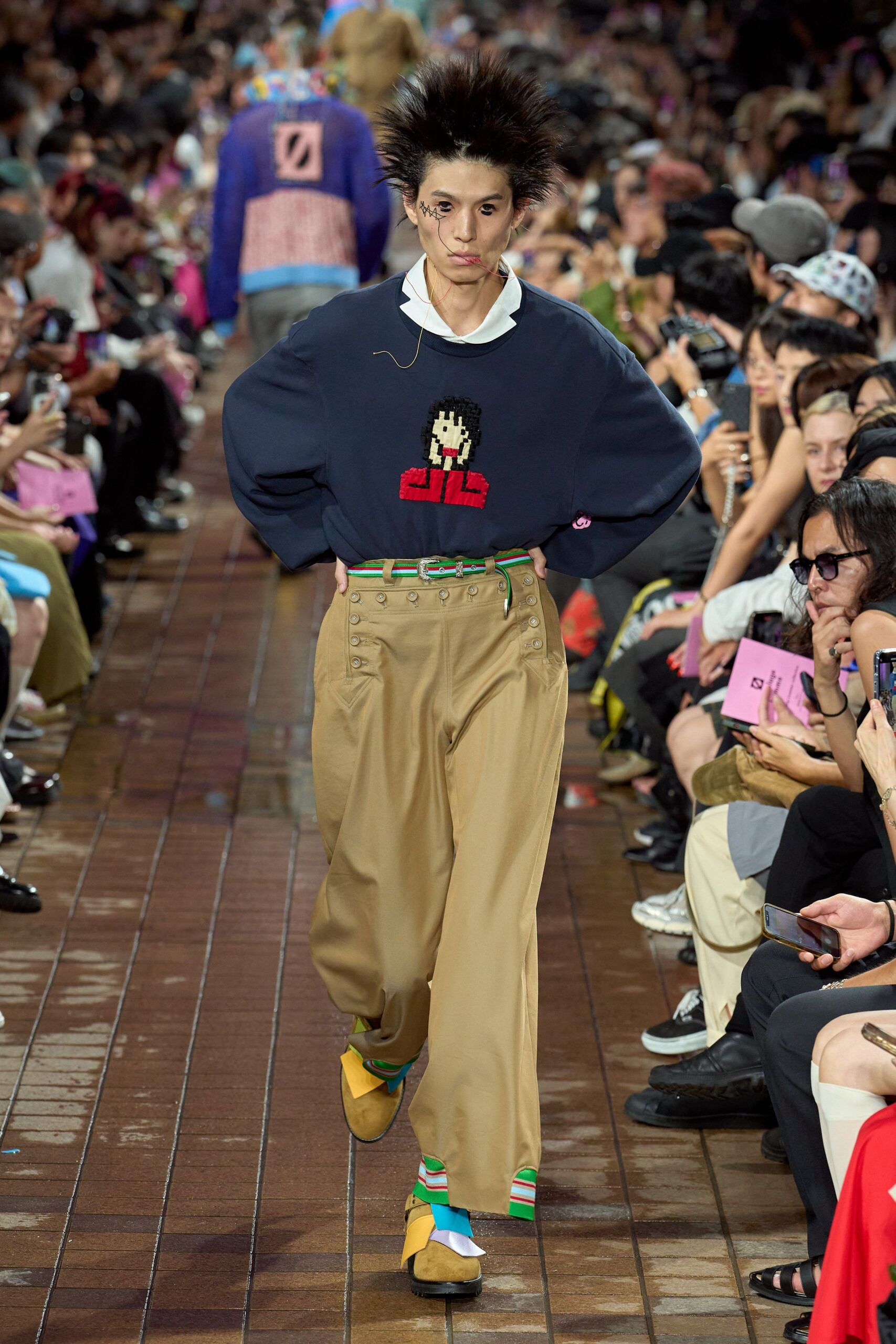 navy relaxed sweater with beige pants