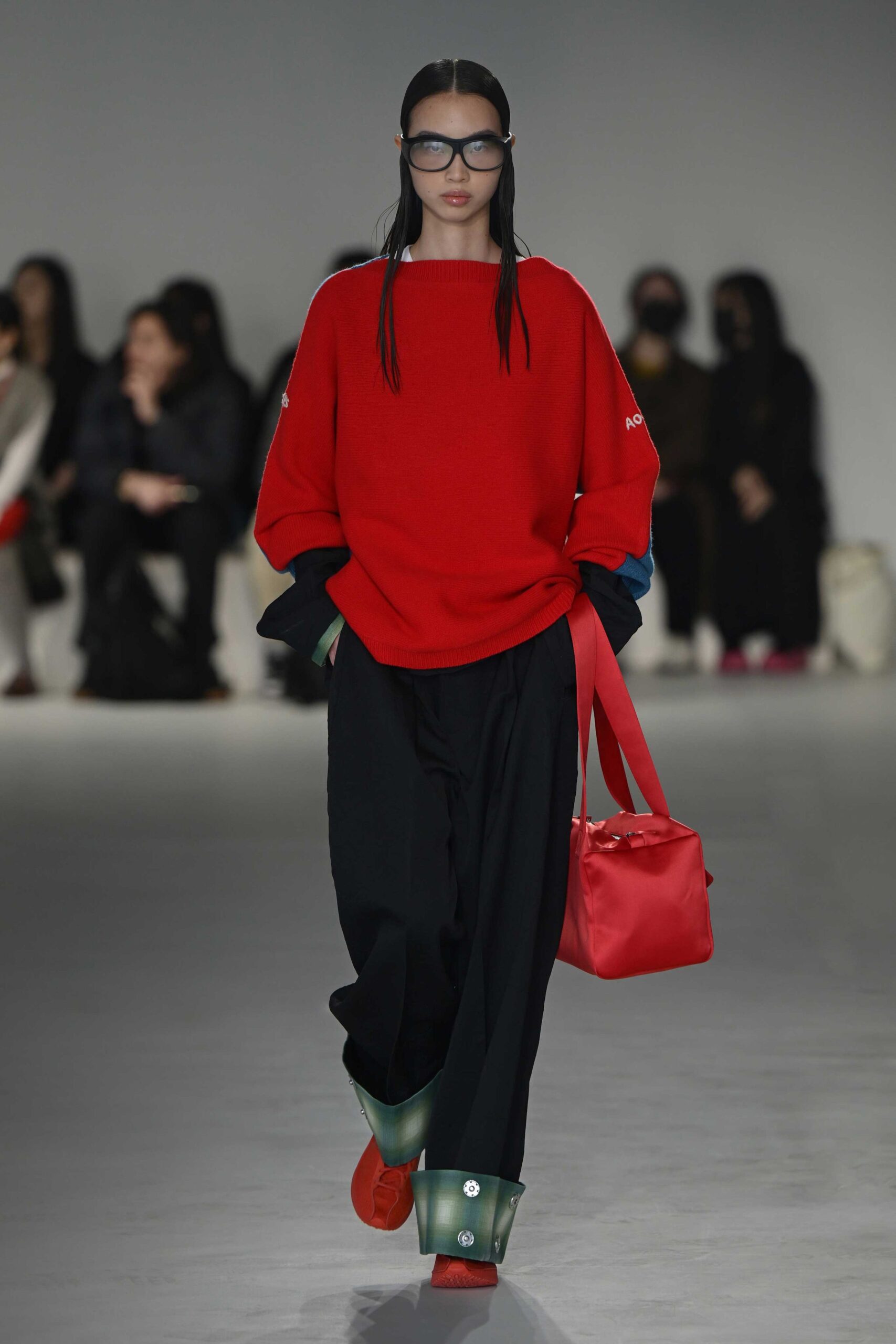 red oversized sweater with black pants