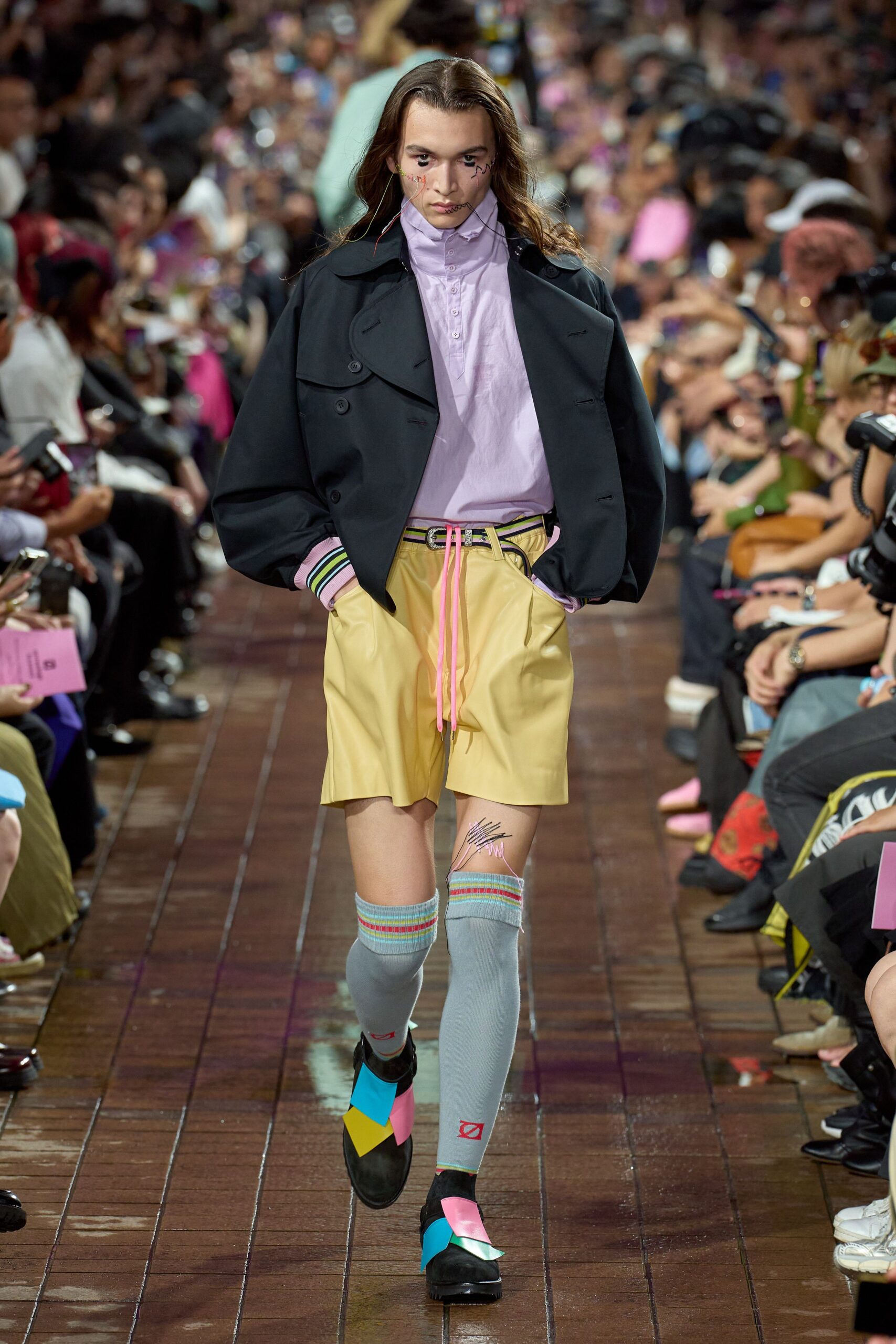 black jacket purple shirt yellow shorts