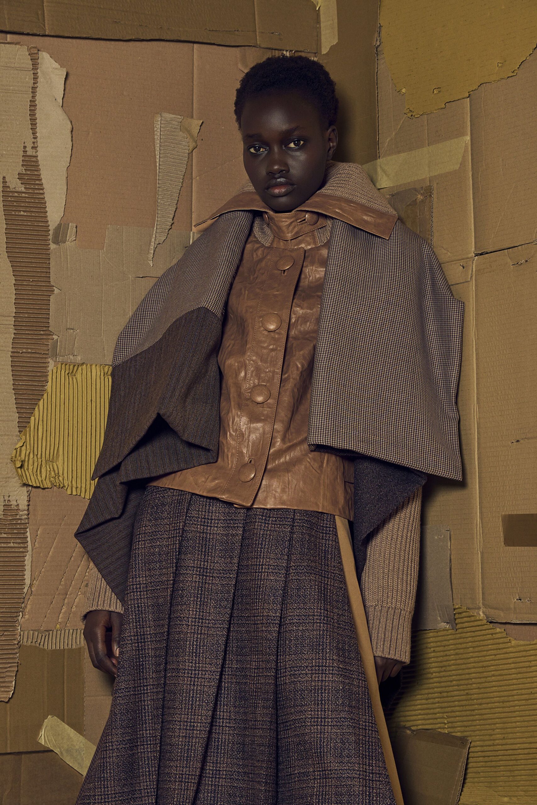 brown leather coat and pleated skirt