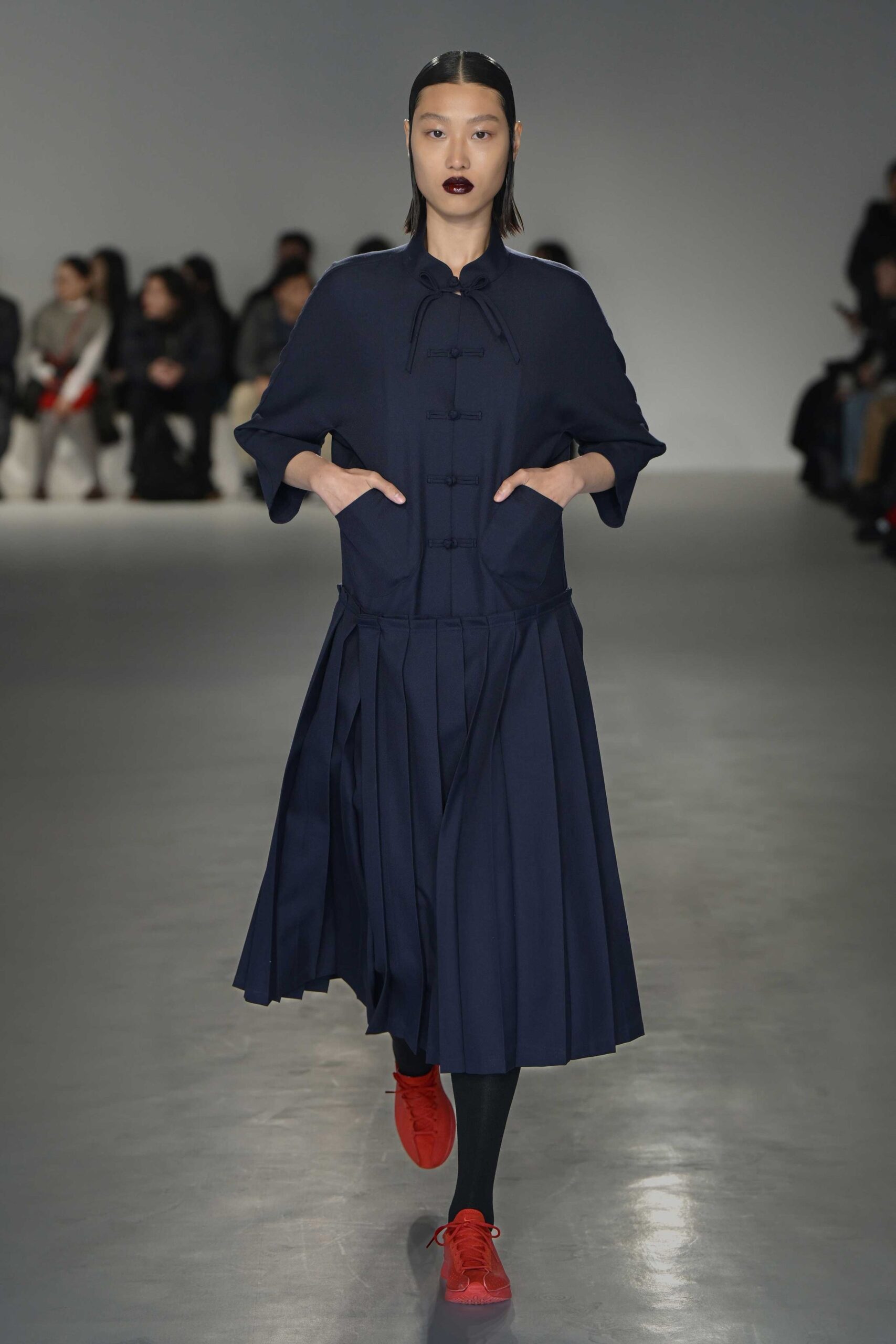 navy pleated midi dress with red shoes