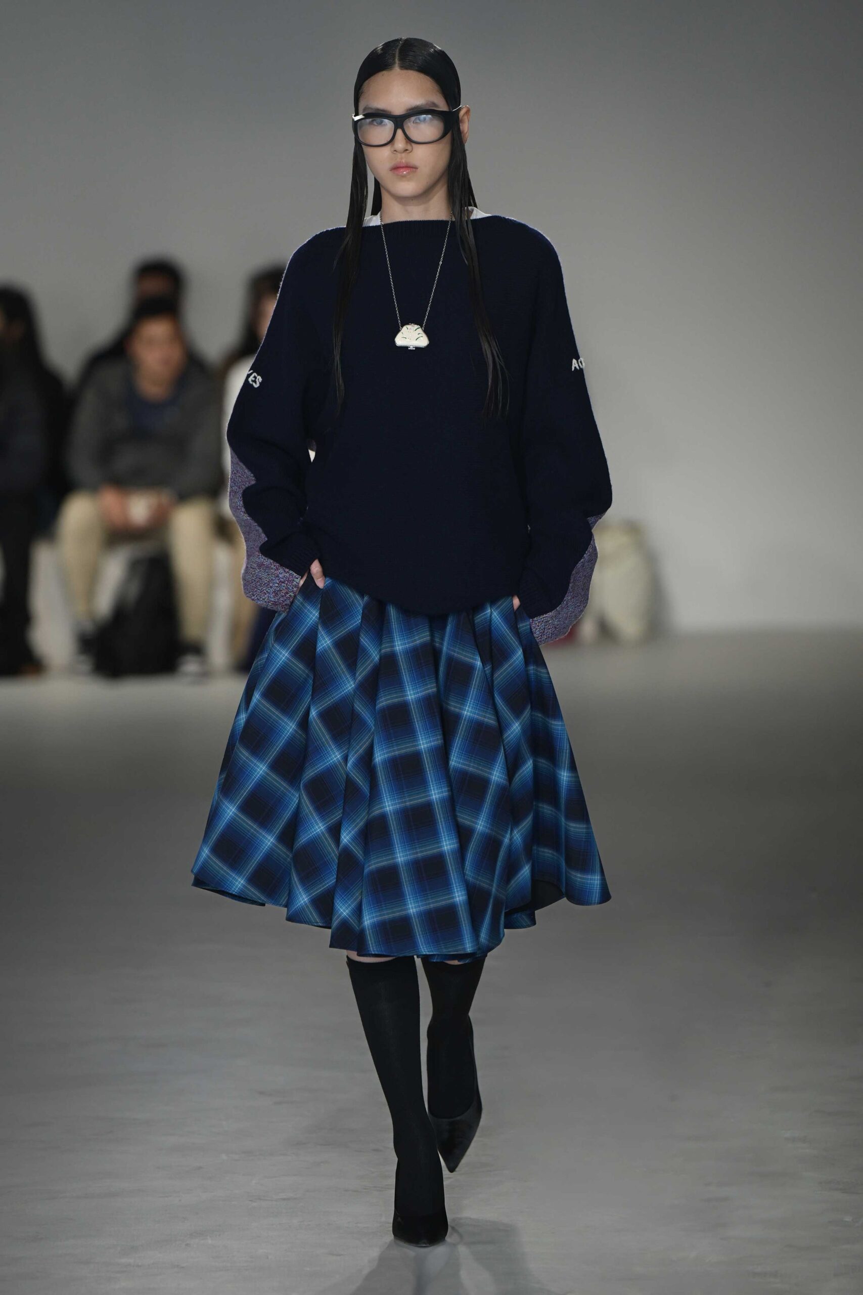 navy sweater with pleated blue skirt