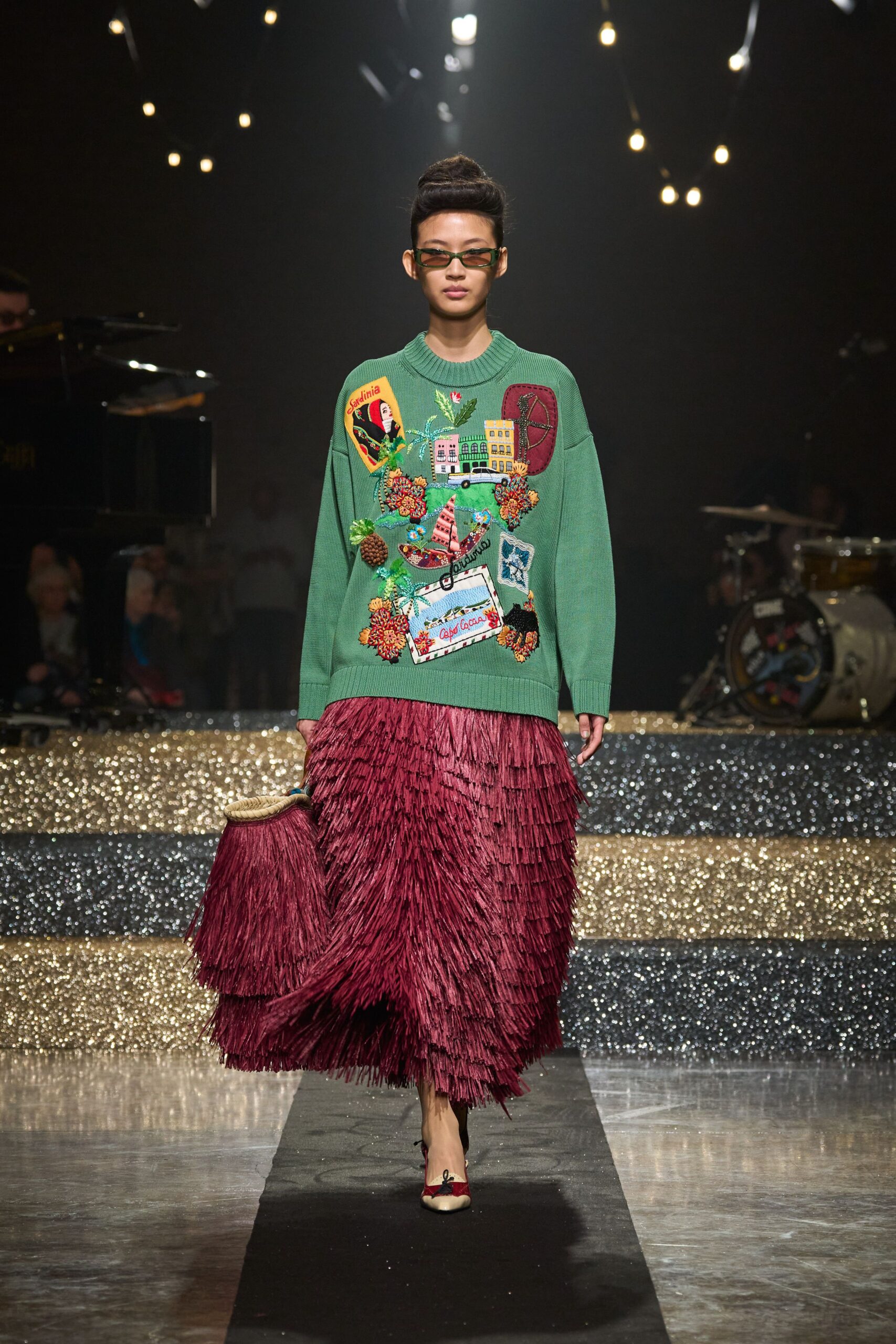 green embroidered sweater with red fringed skirt