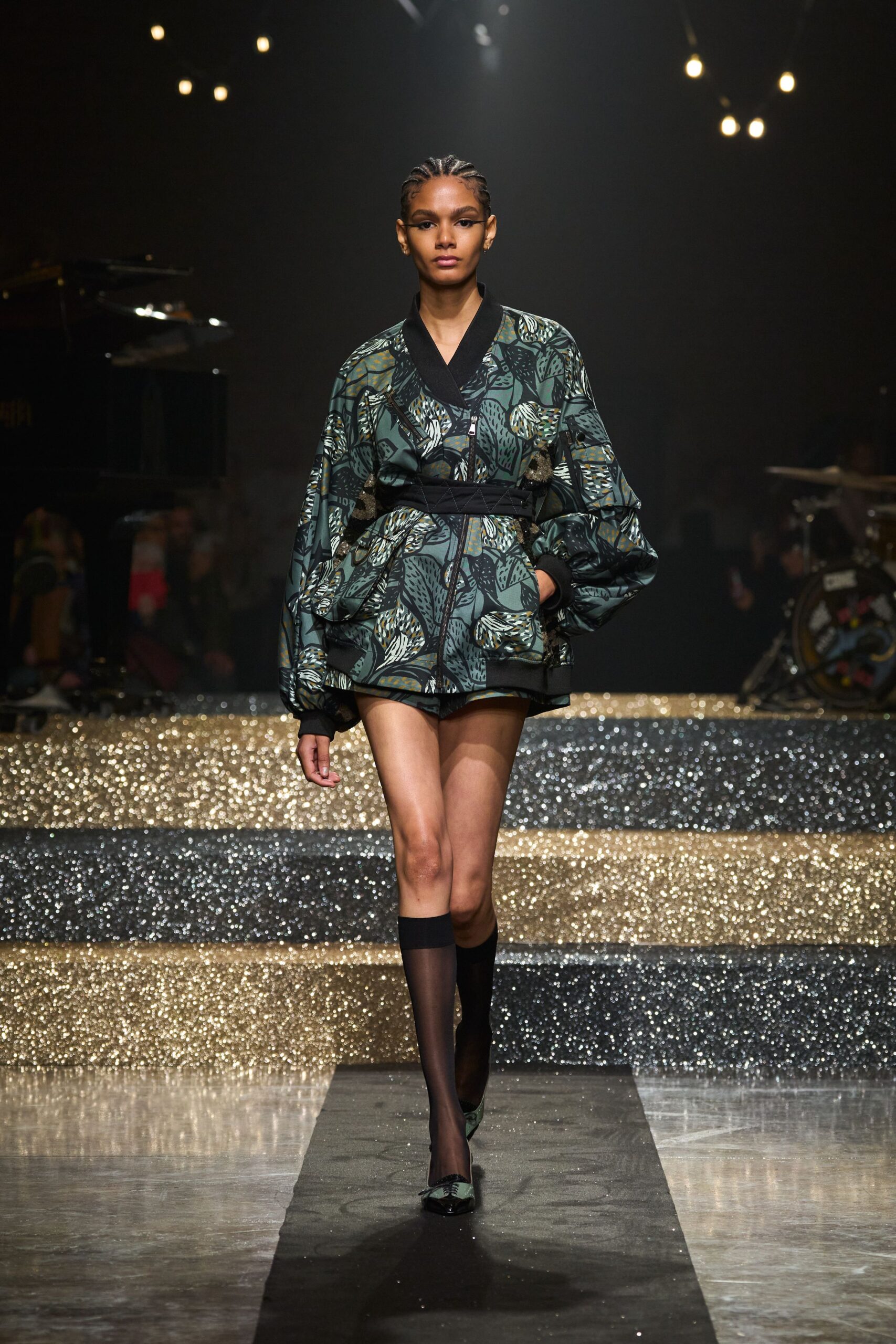 green printed relaxed jacket with black shorts