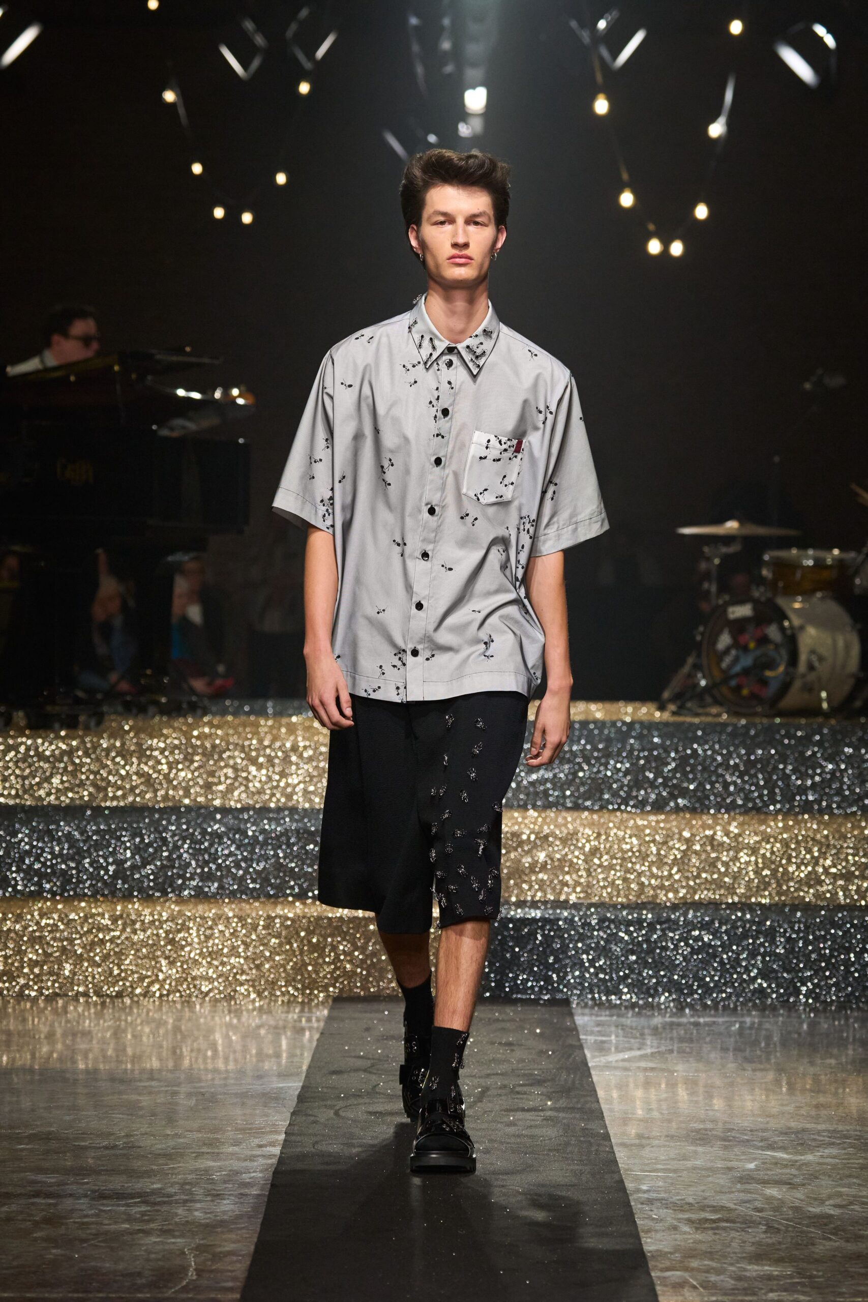 gray collared shirt with black shorts