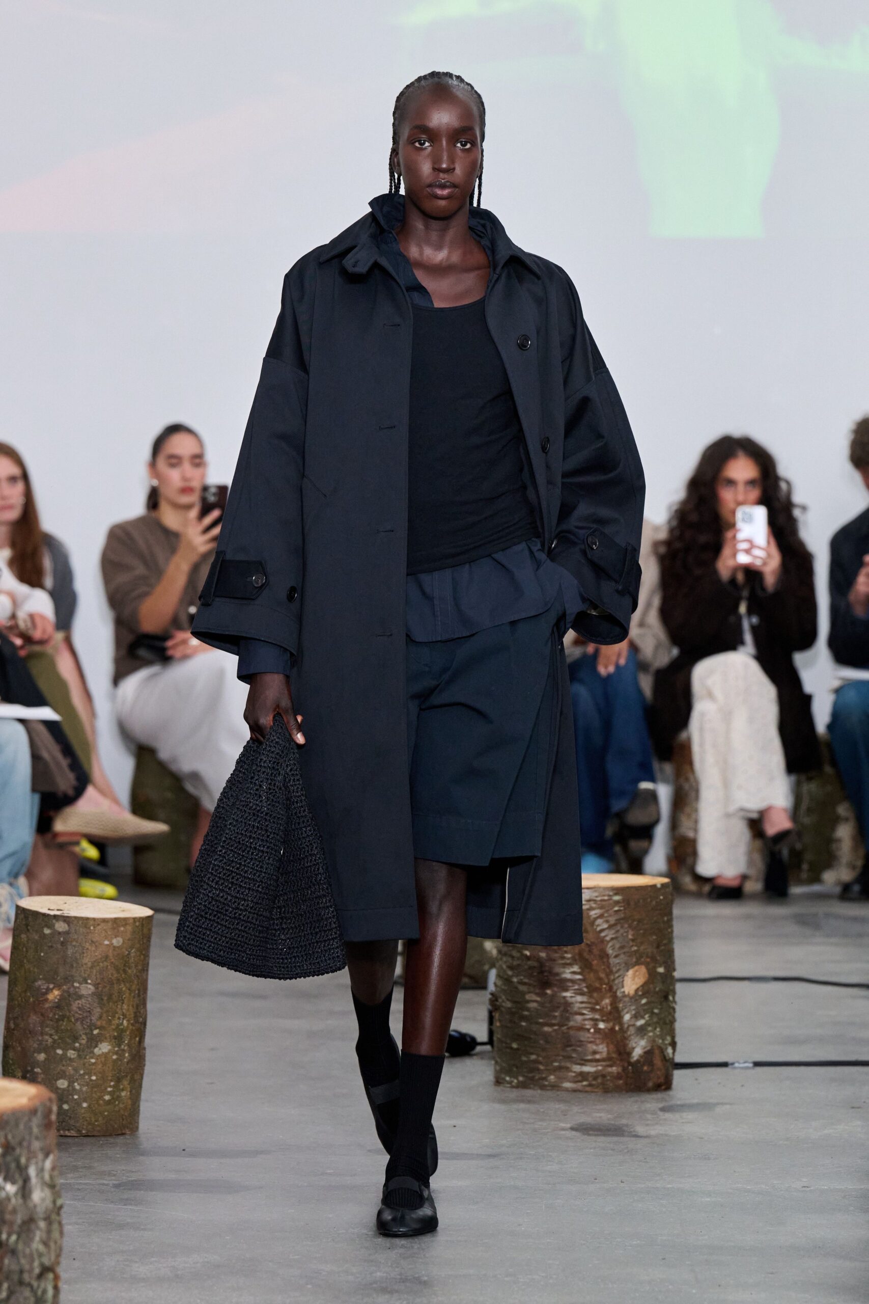 black oversized coat with pleated skirt