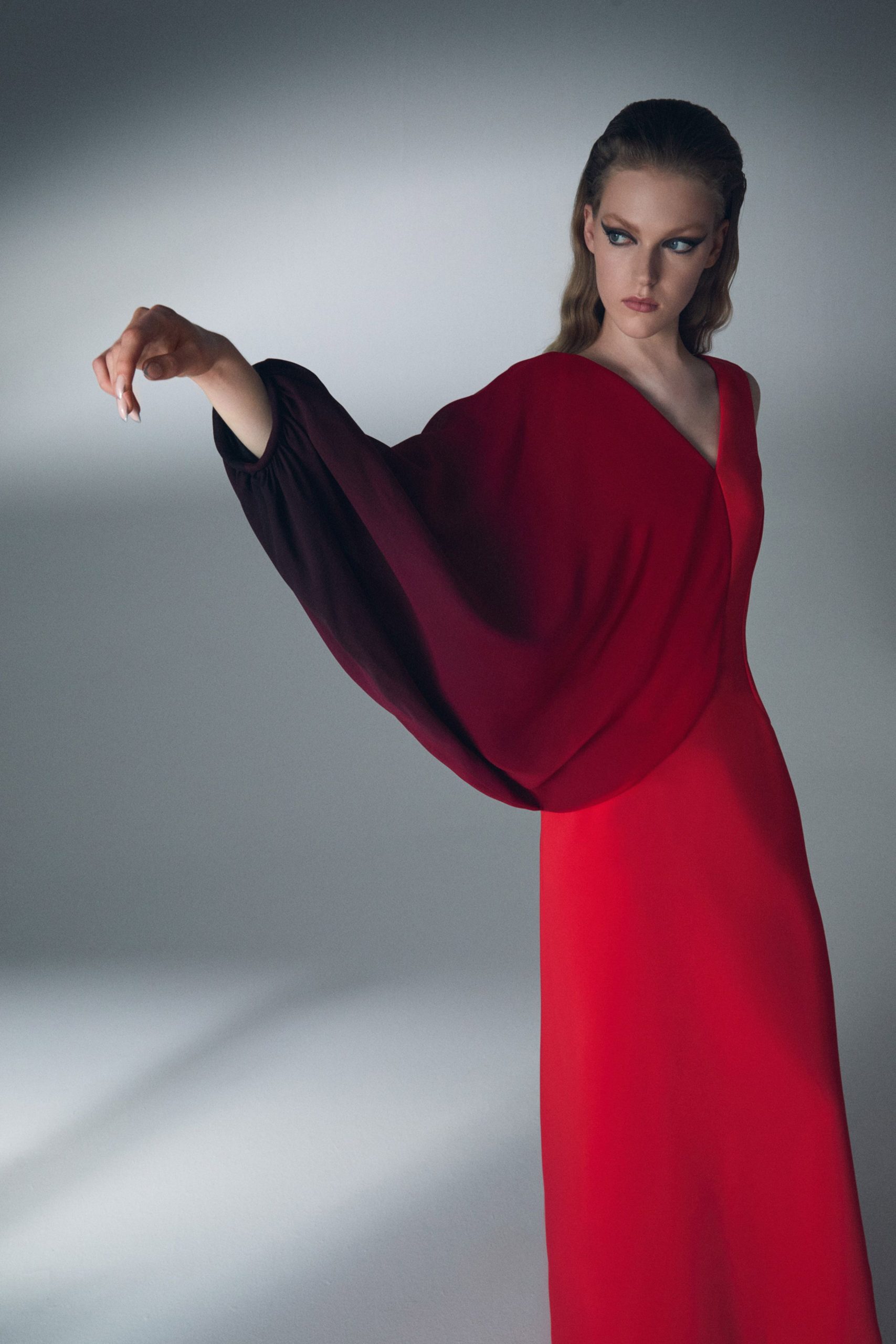 red and black draped gown