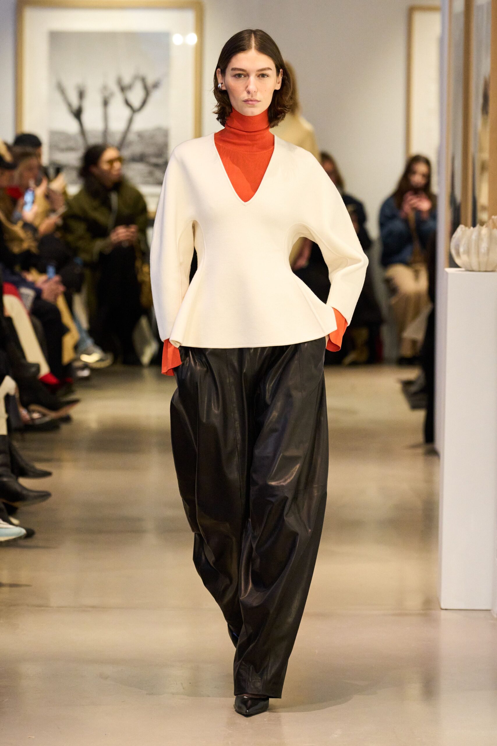 white top with red underlayer and black pants