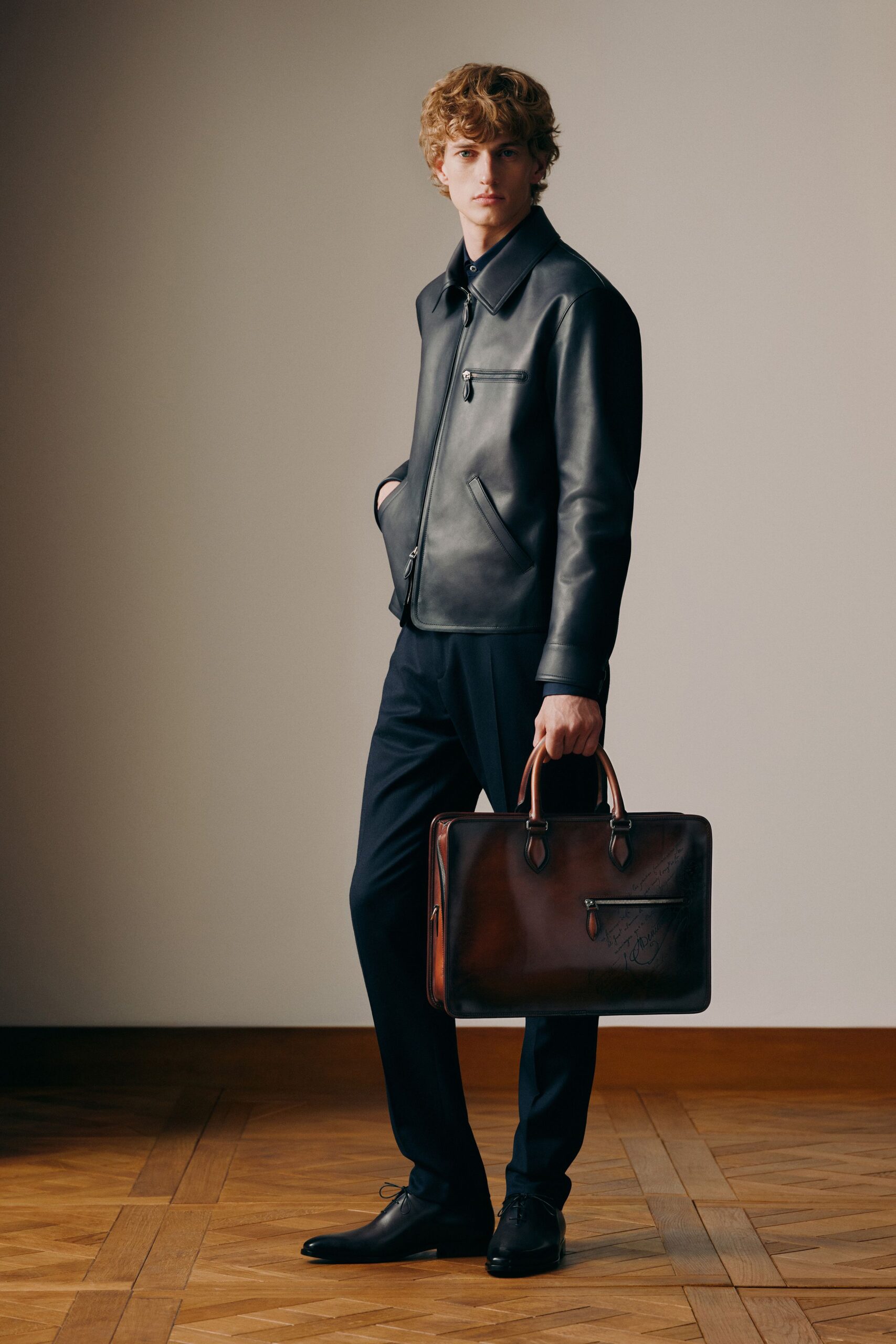 black leather jacket with brown bag