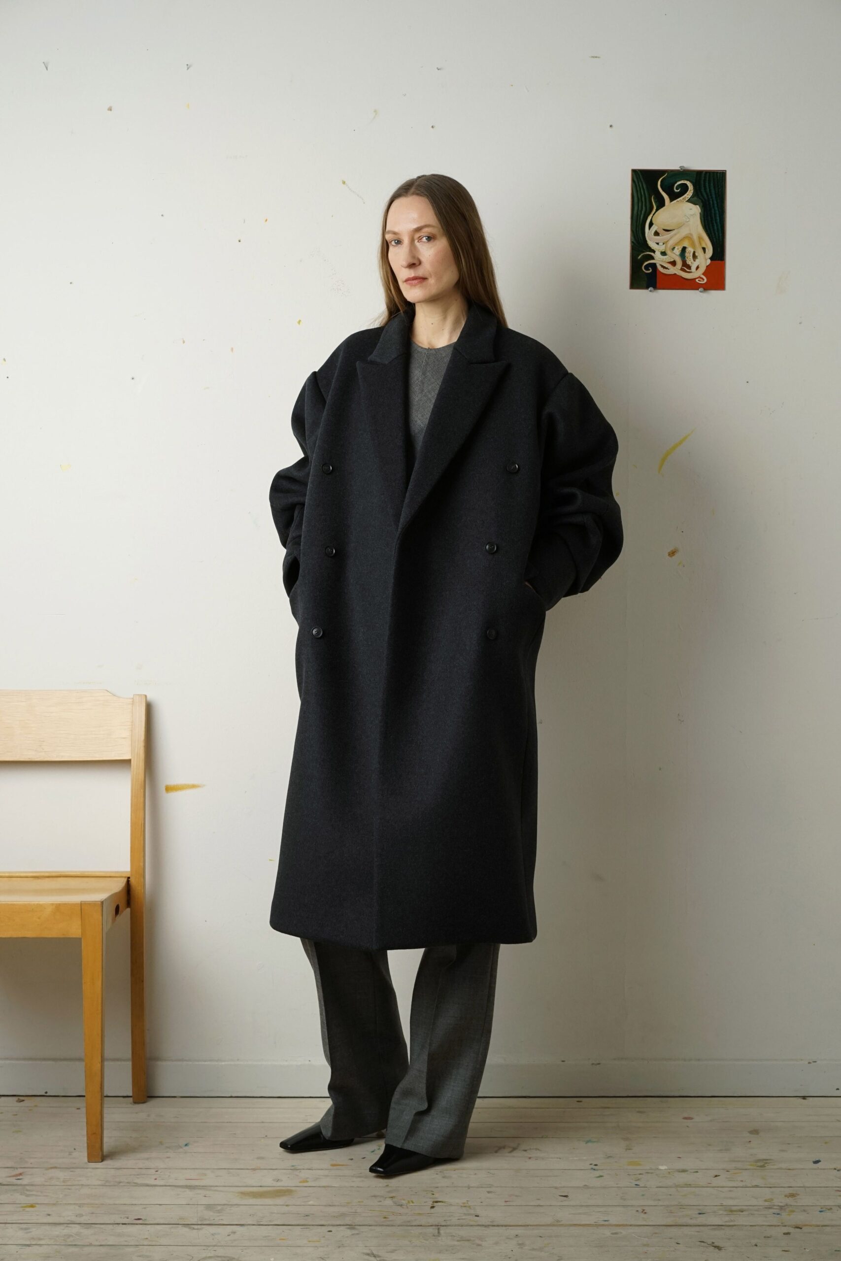 black oversized wool coat and gray tailored pants