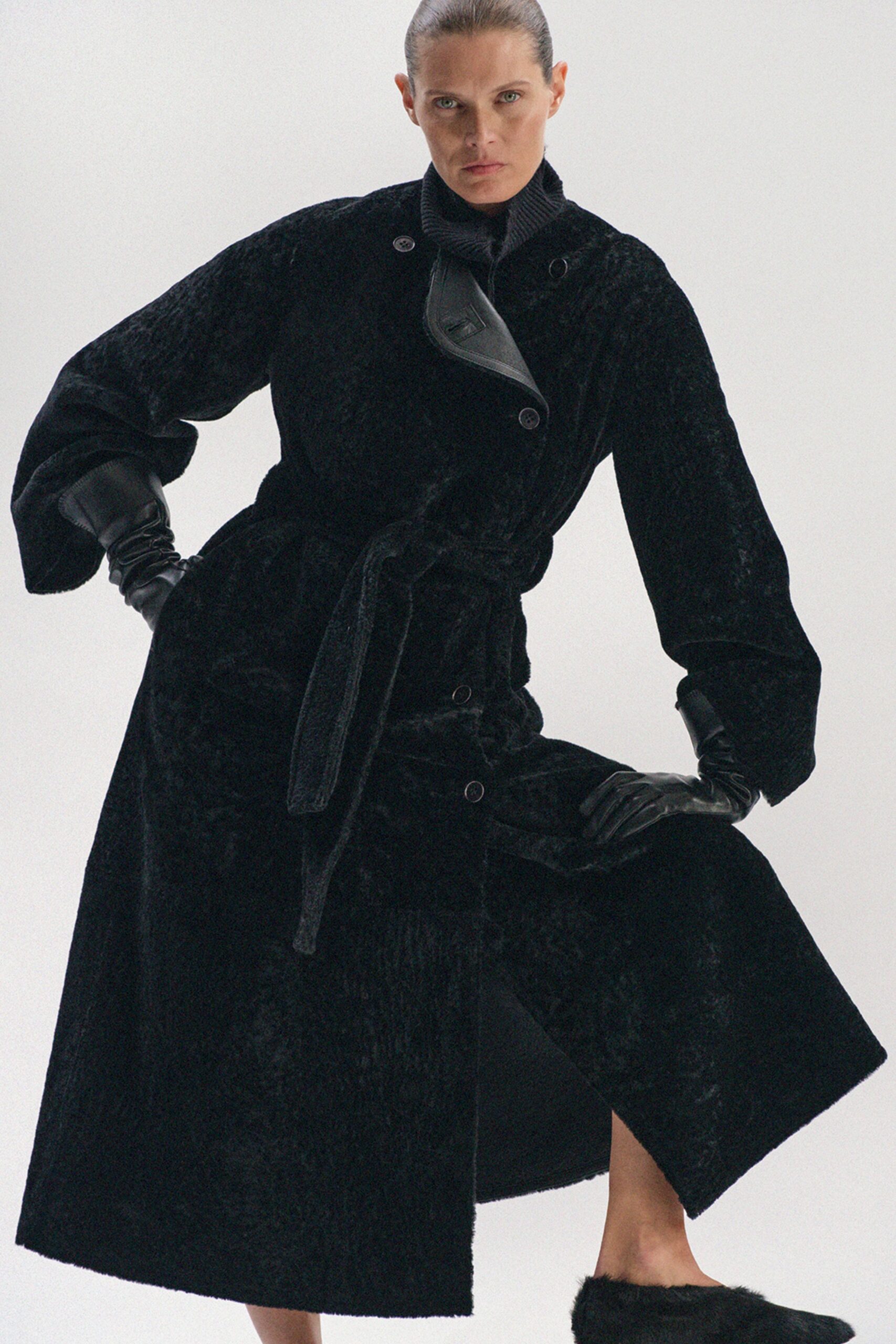 black faux-fur coat with gloves