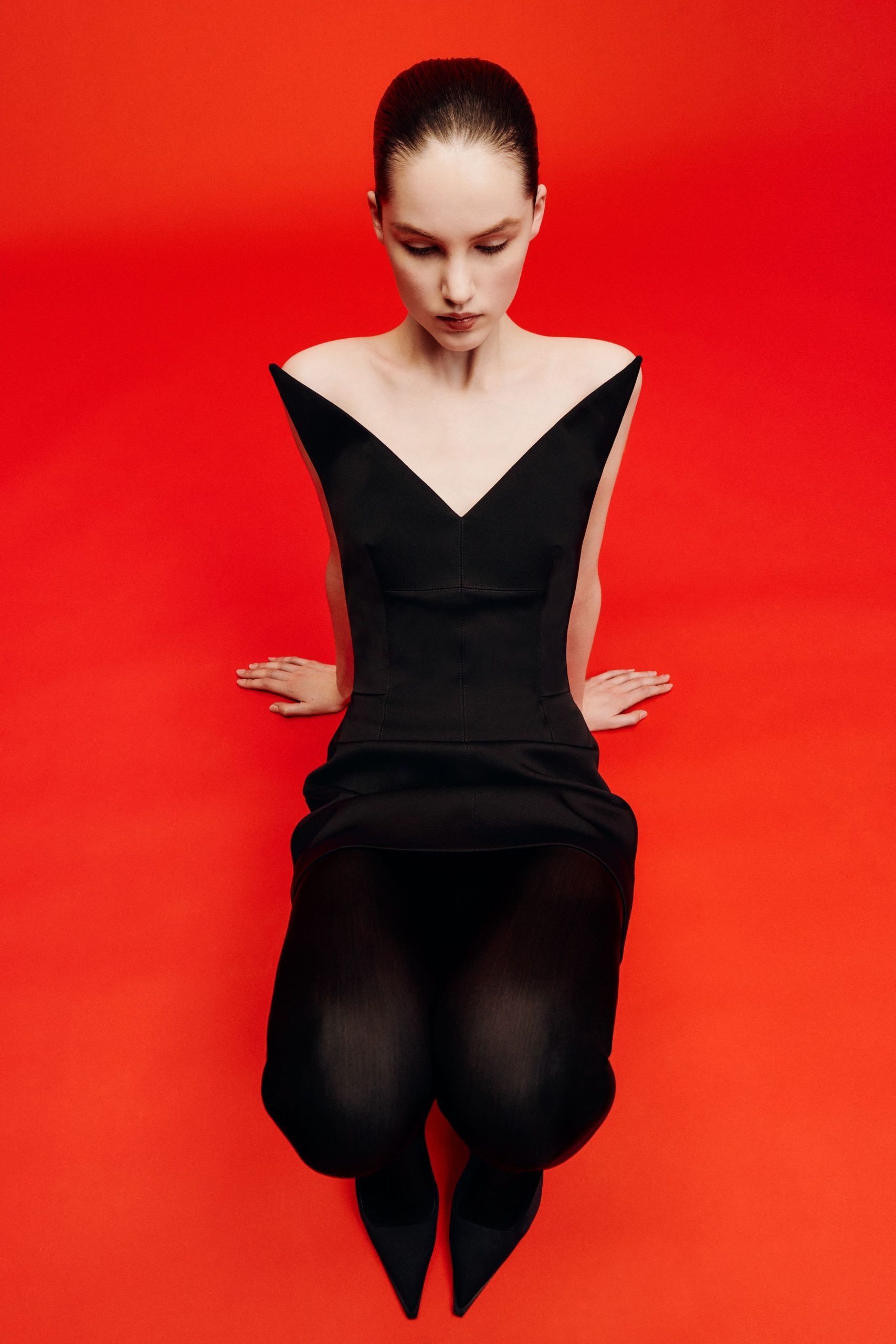 black fitted mini dress with pointed shoes