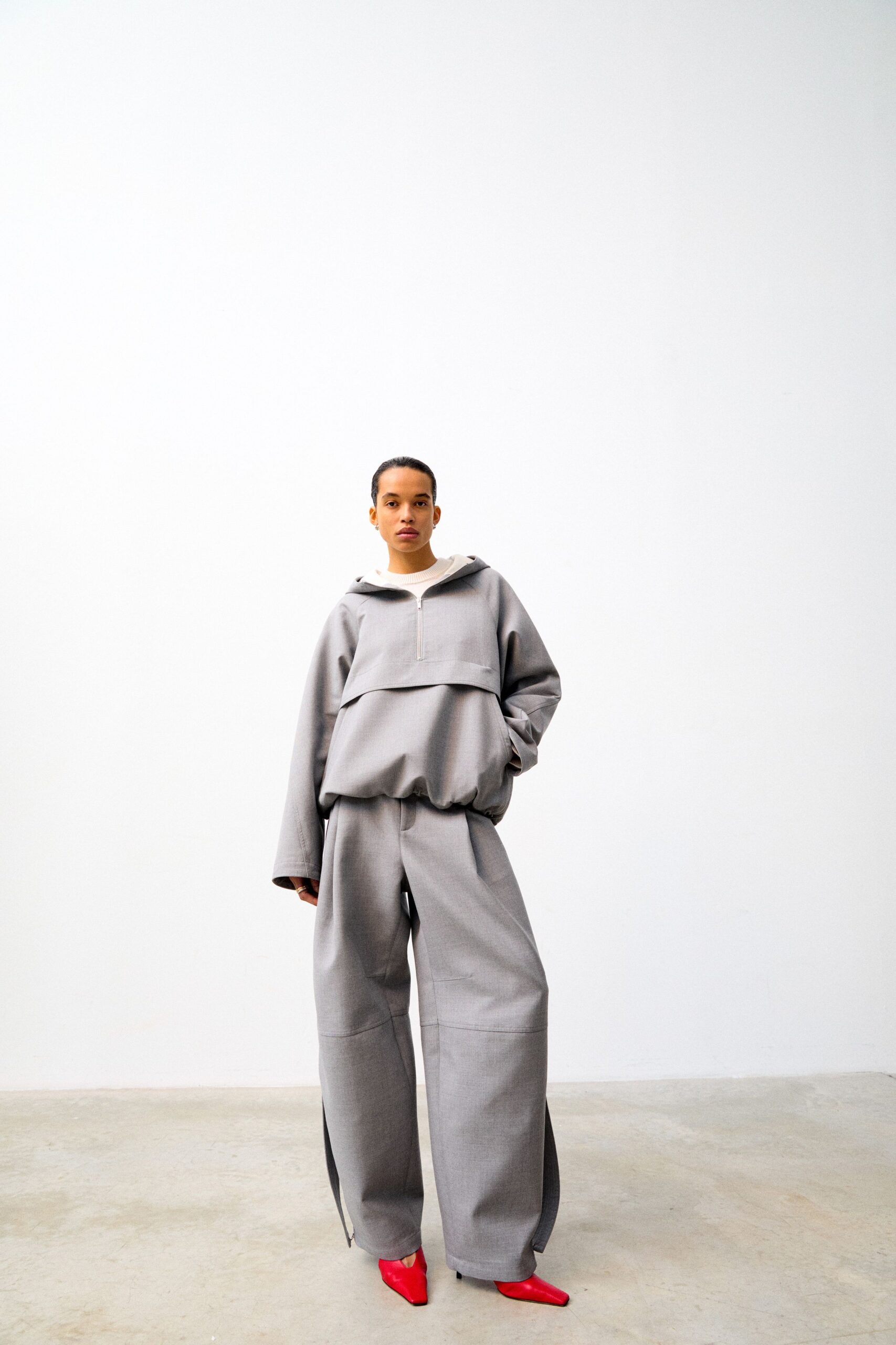 gray relaxed hoodie and pants with red heels