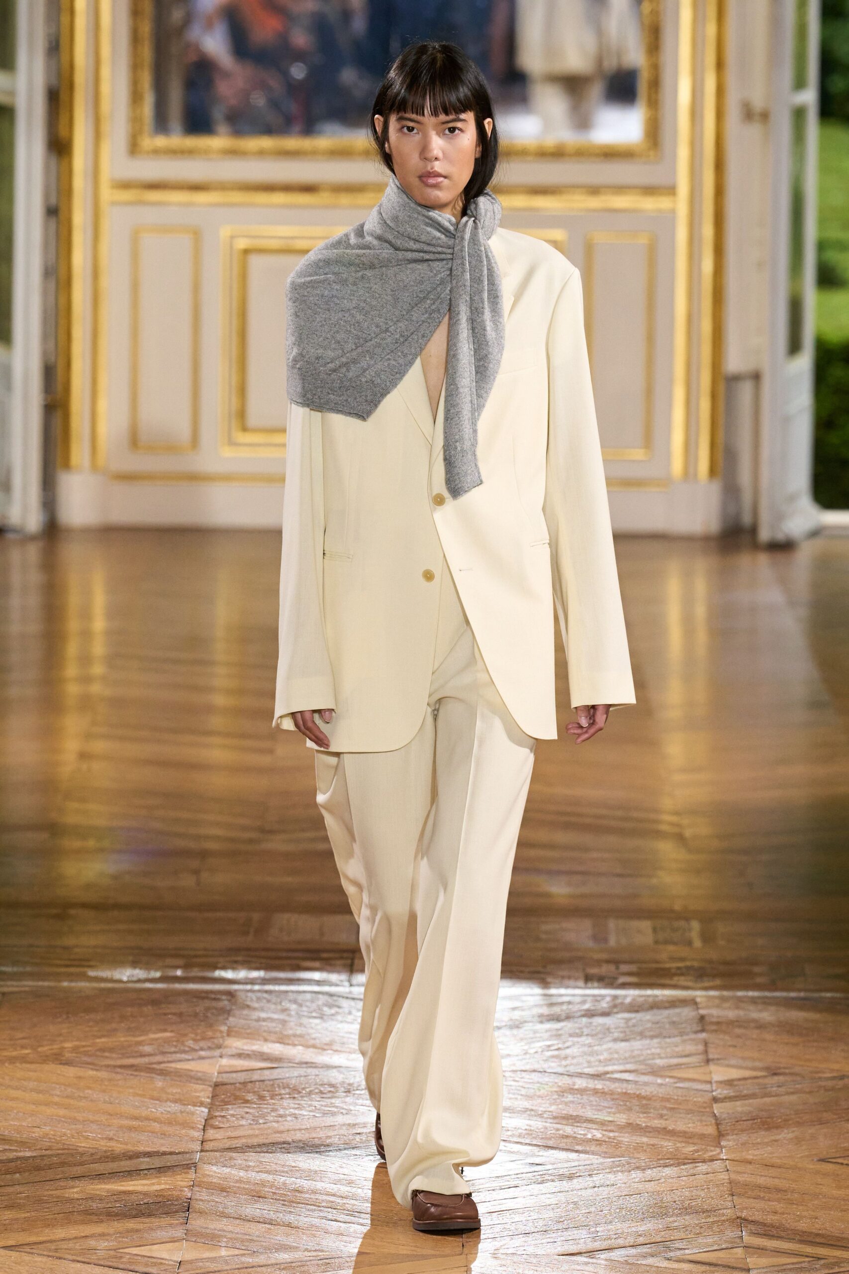 beige tailored suit with gray scarf