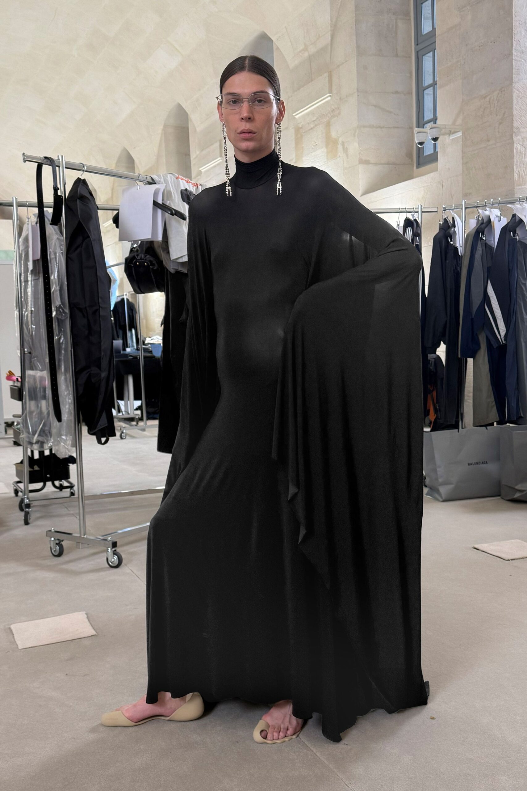 black draped long-sleeve gown with beige shoes
