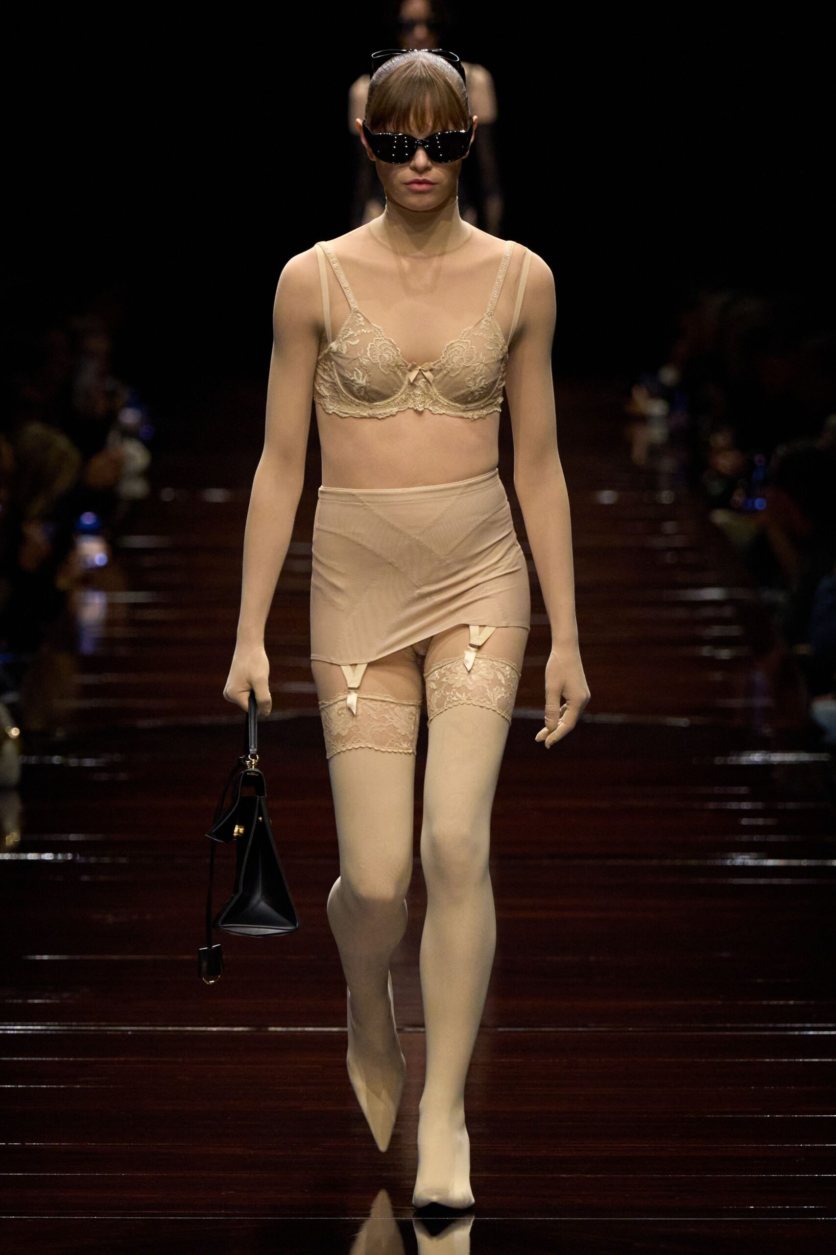 beige bodysuit and skirt with black accessories
