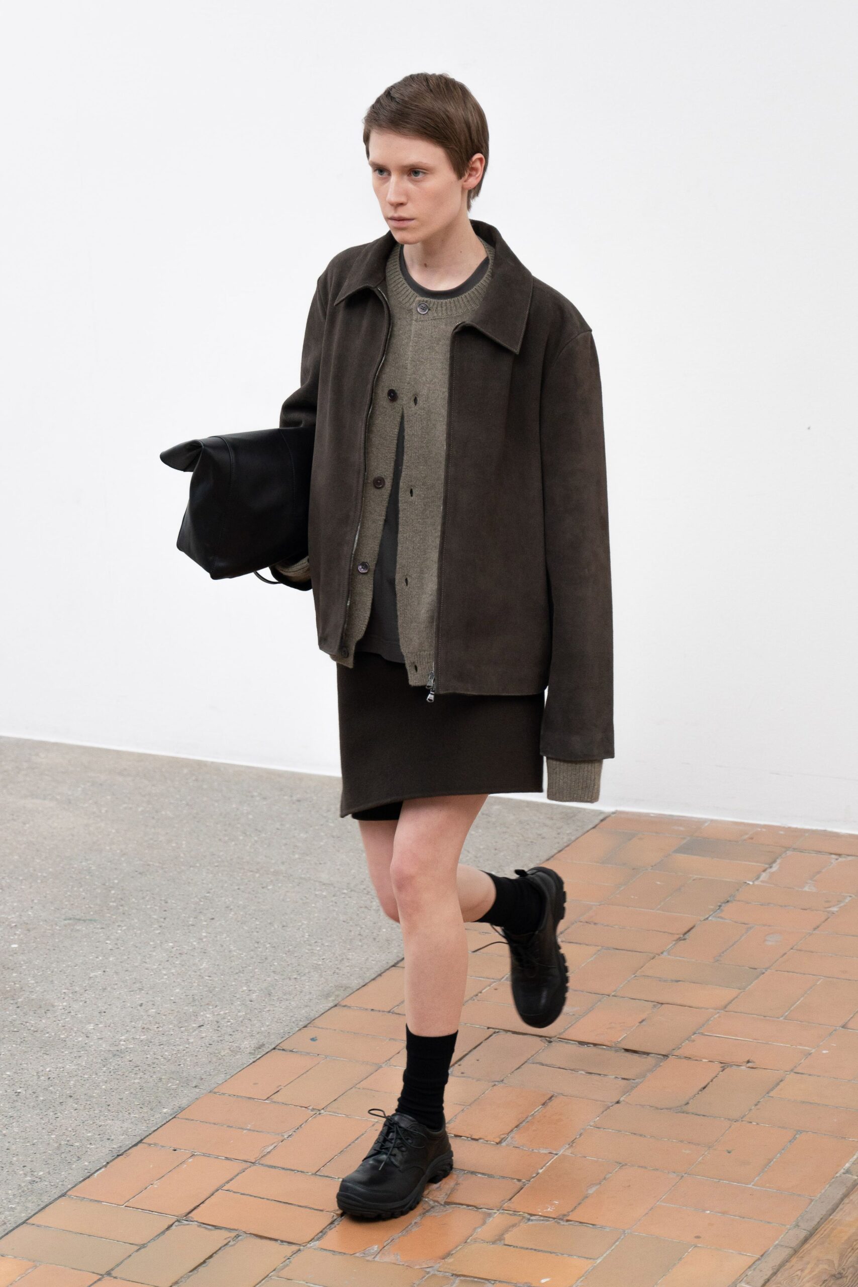 brown suede jacket gray sweater black skirt