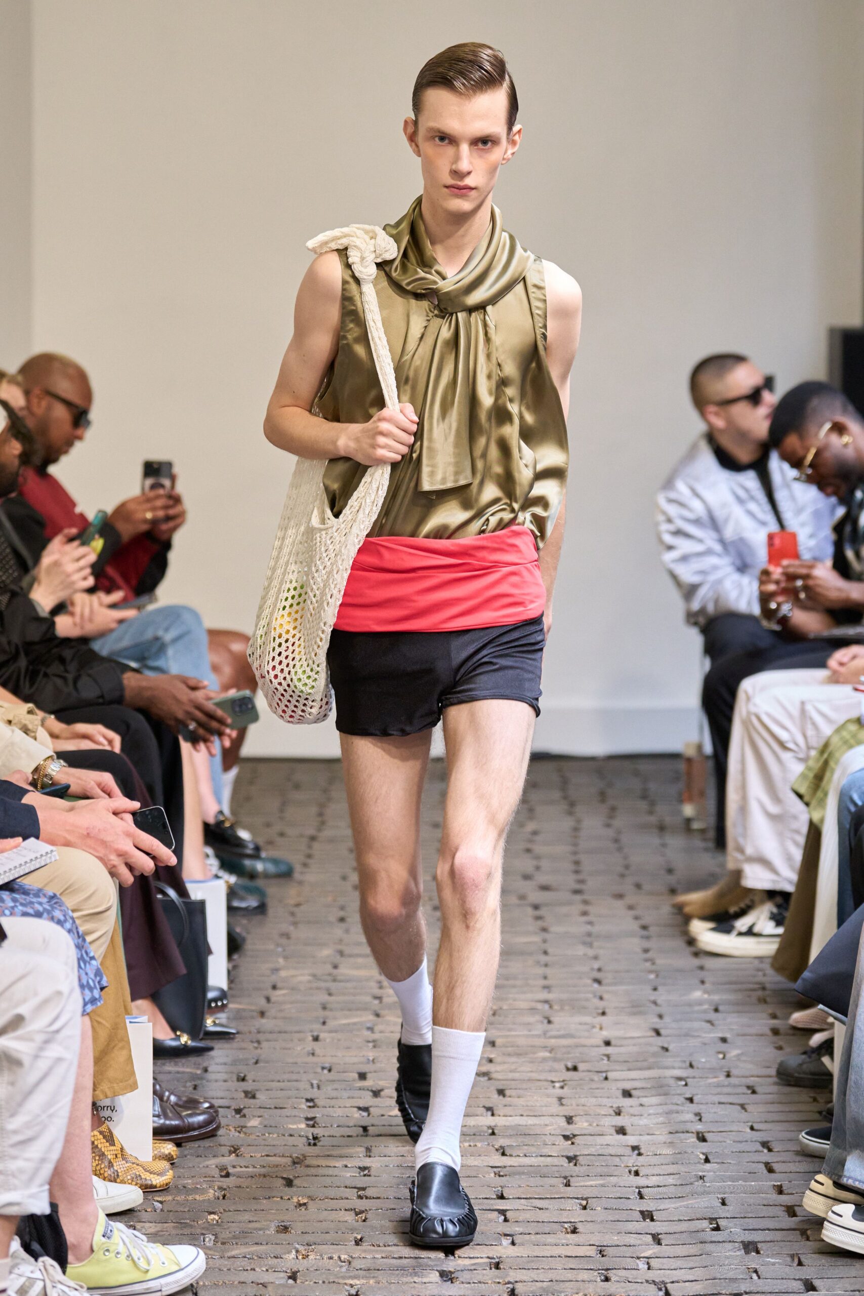 olive silk sleeveless top with black shorts
