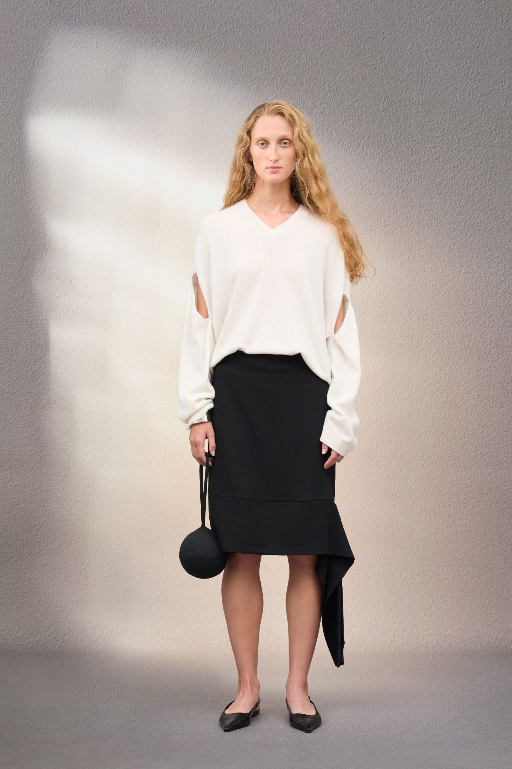 white relaxed top with black skirt