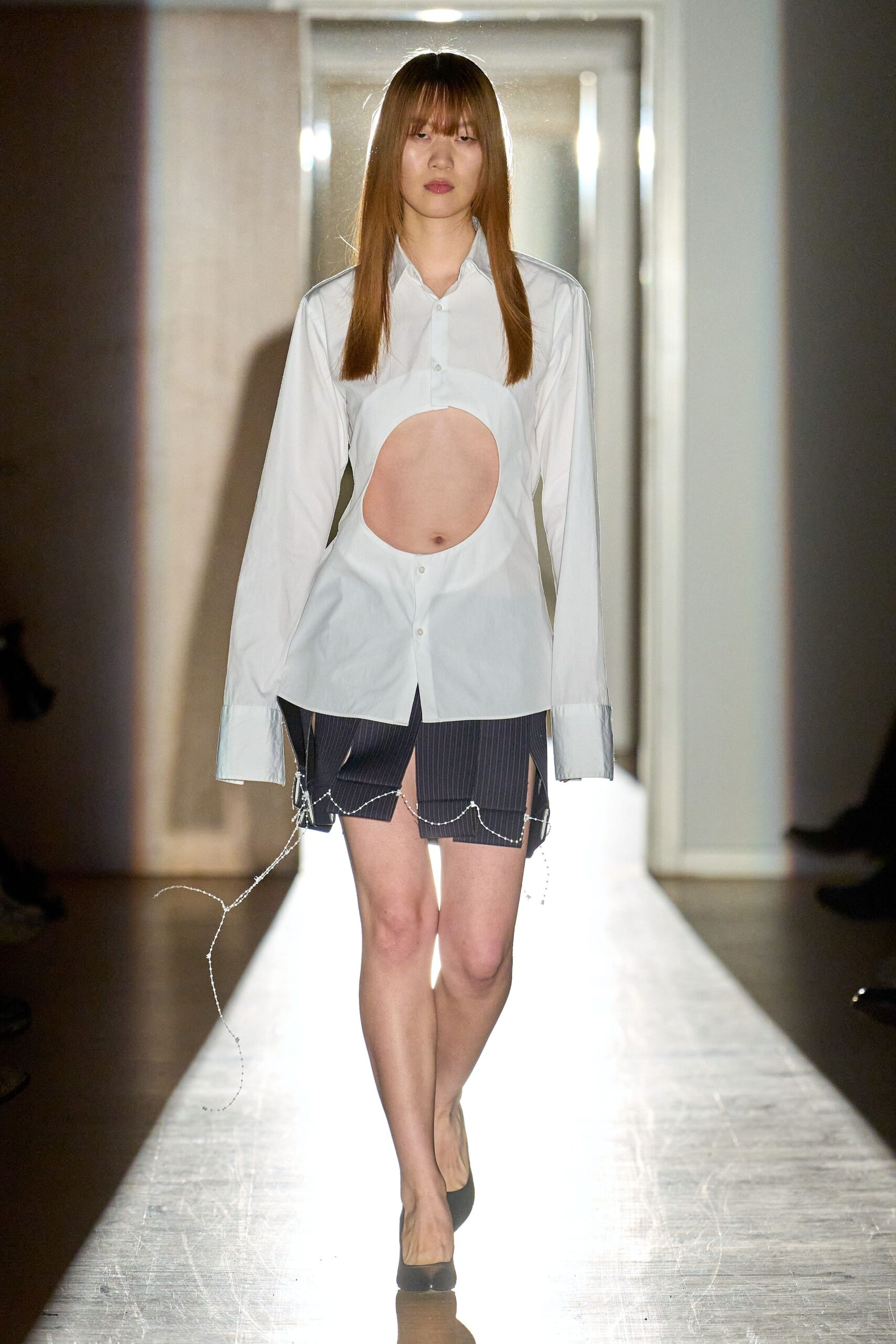 white cutout shirt with navy shorts