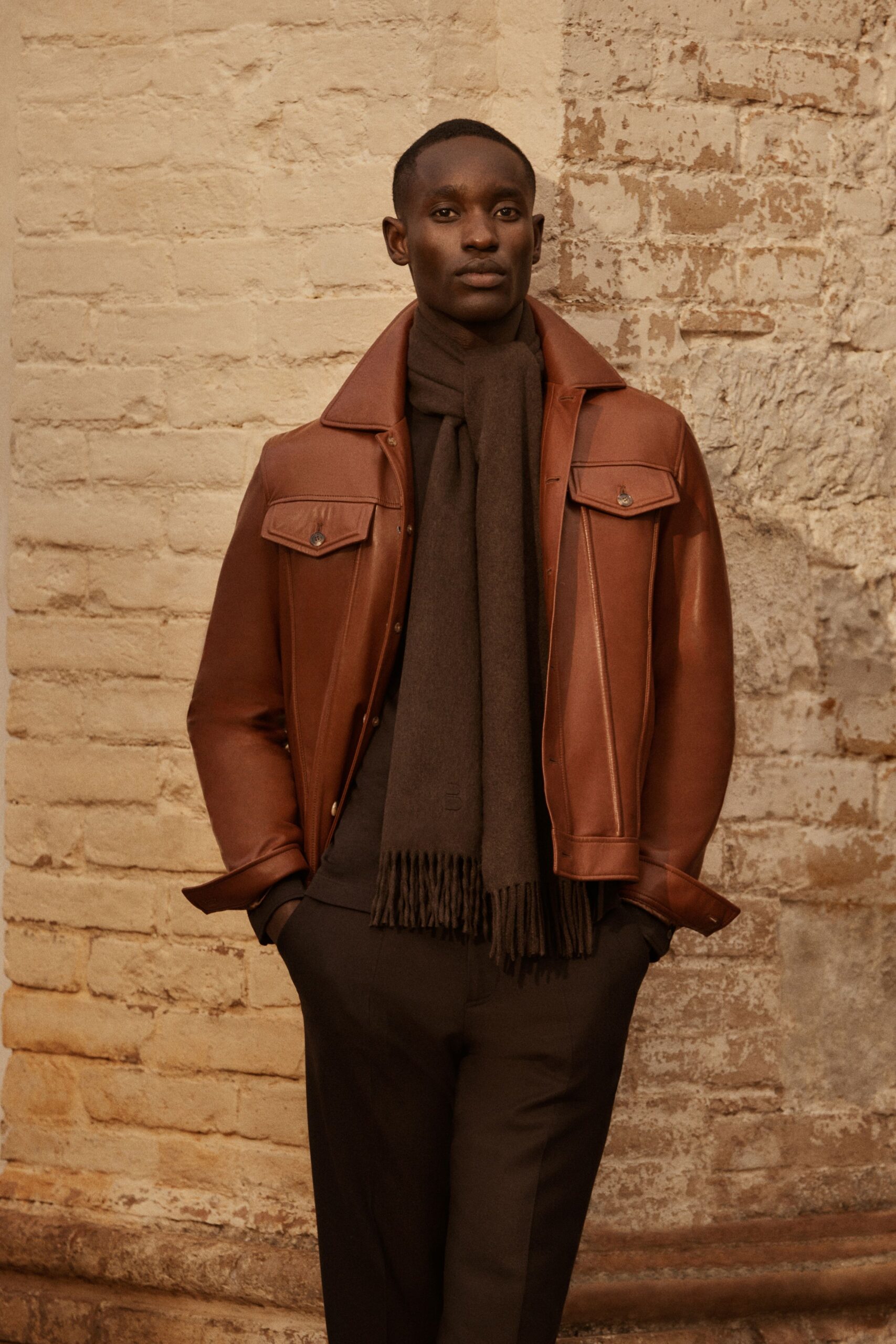 brown leather jacket with gray scarf
