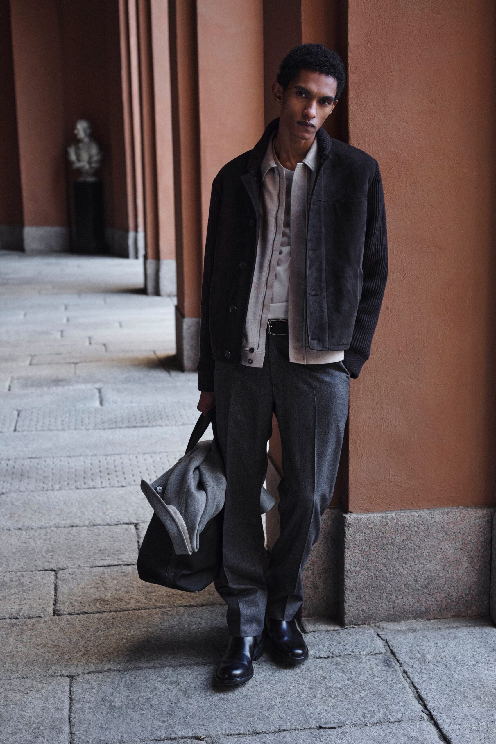 black suede jacket beige shirt gray pants