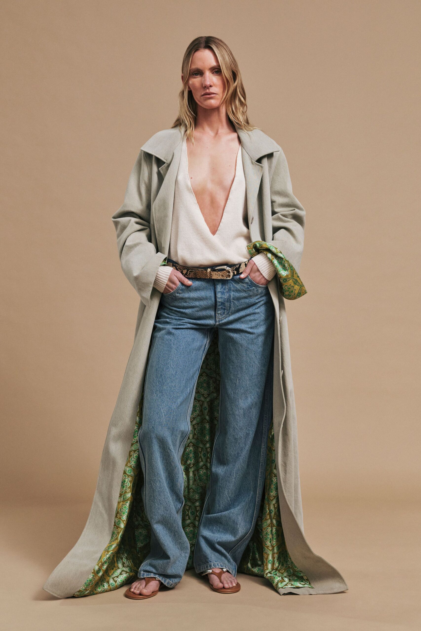 gray coat white top blue jeans
