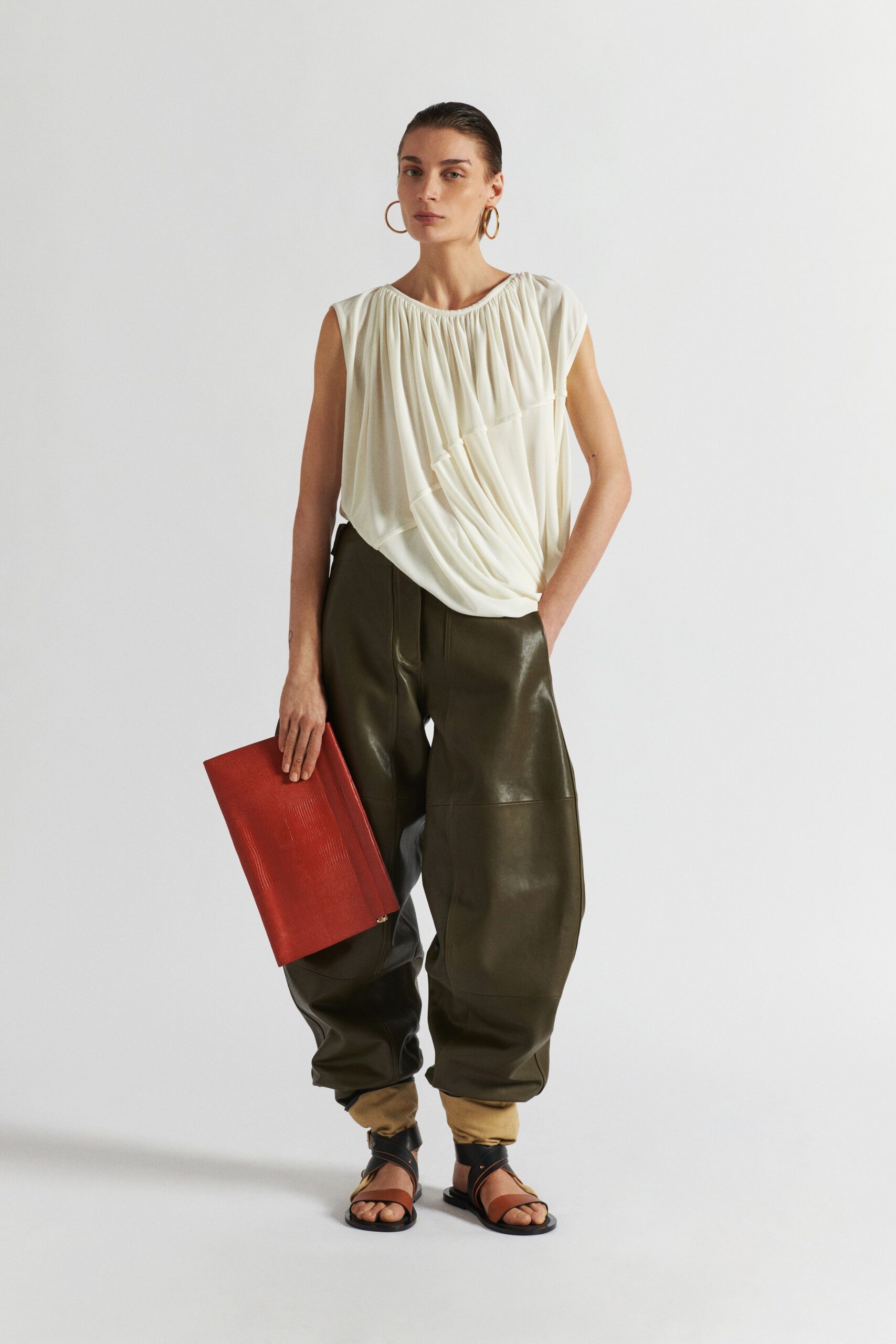 white silk relaxed top with green leather pants