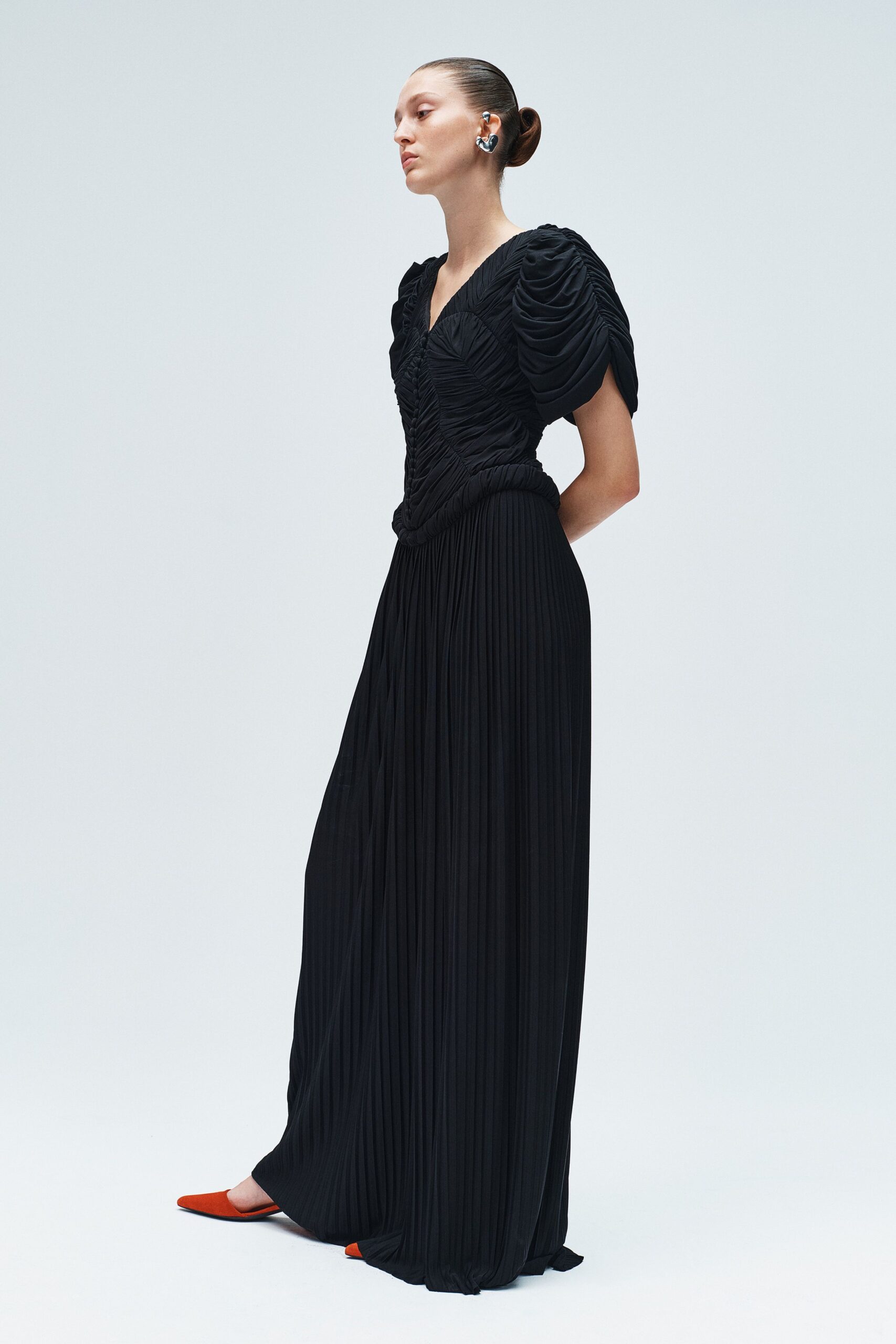black silk pleated gown with red shoes