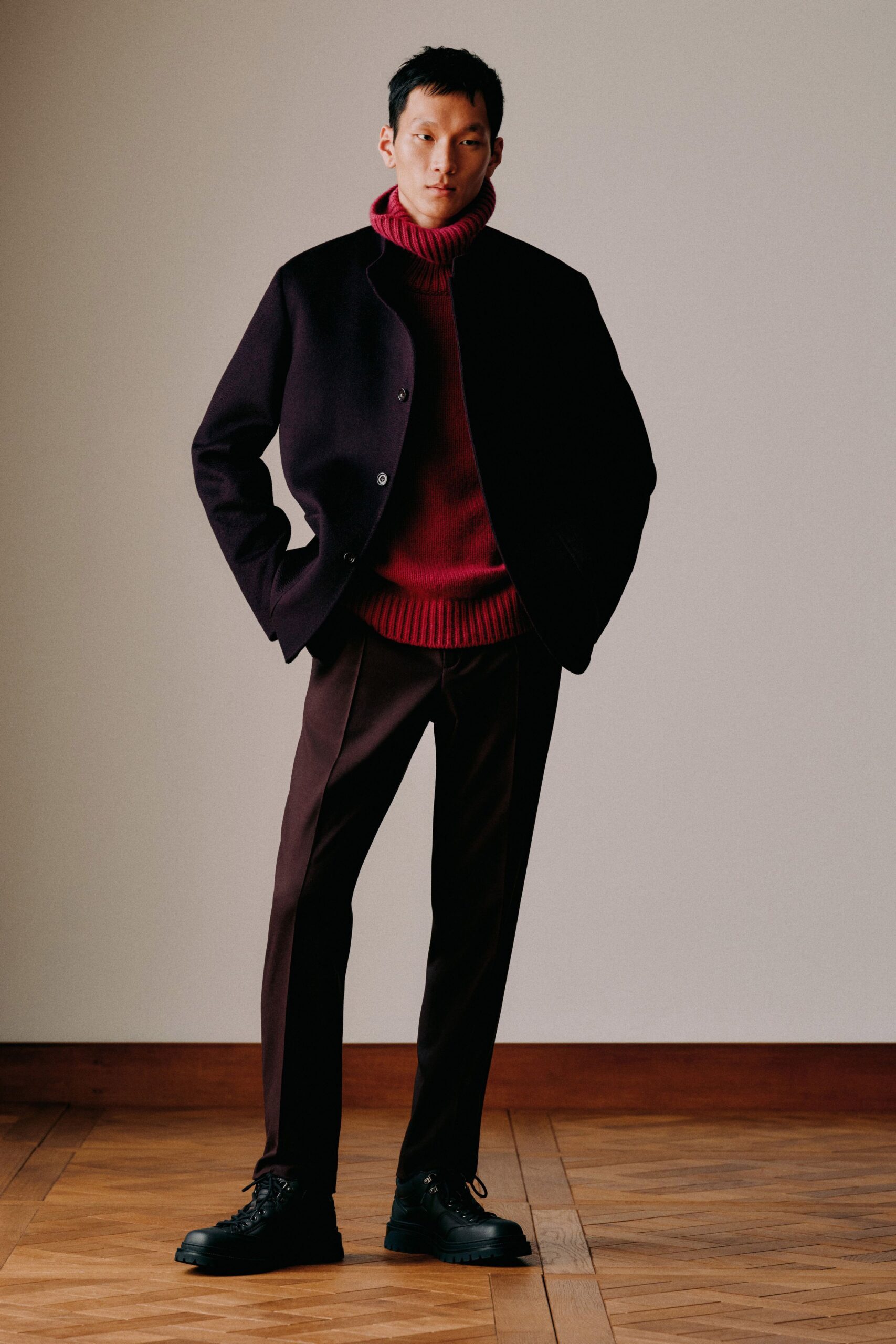 black jacket red sweater brown pants
