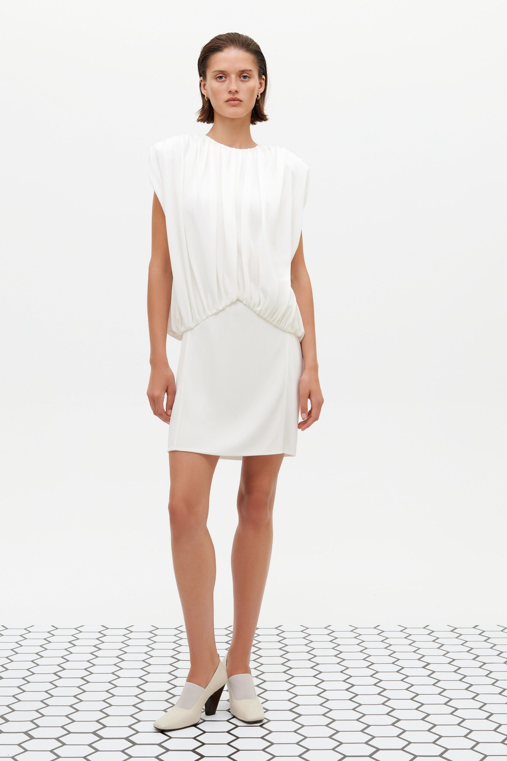 white pleated mini dress with beige shoes