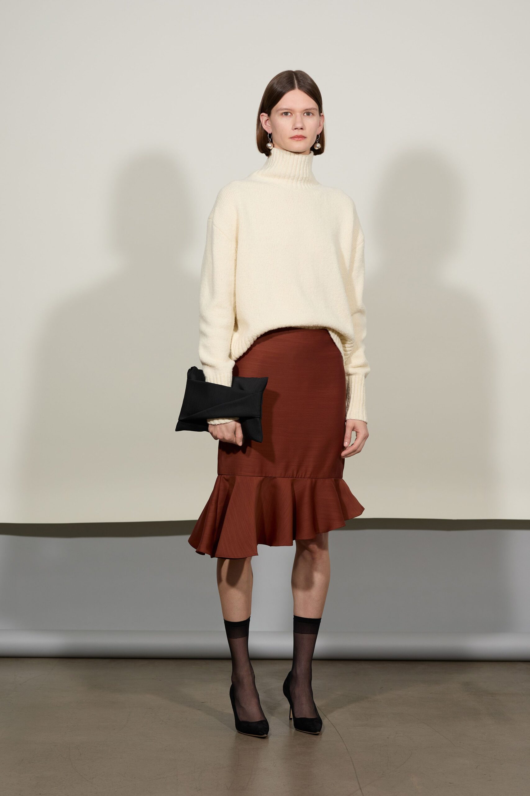 white wool relaxed sweater with brown flared skirt