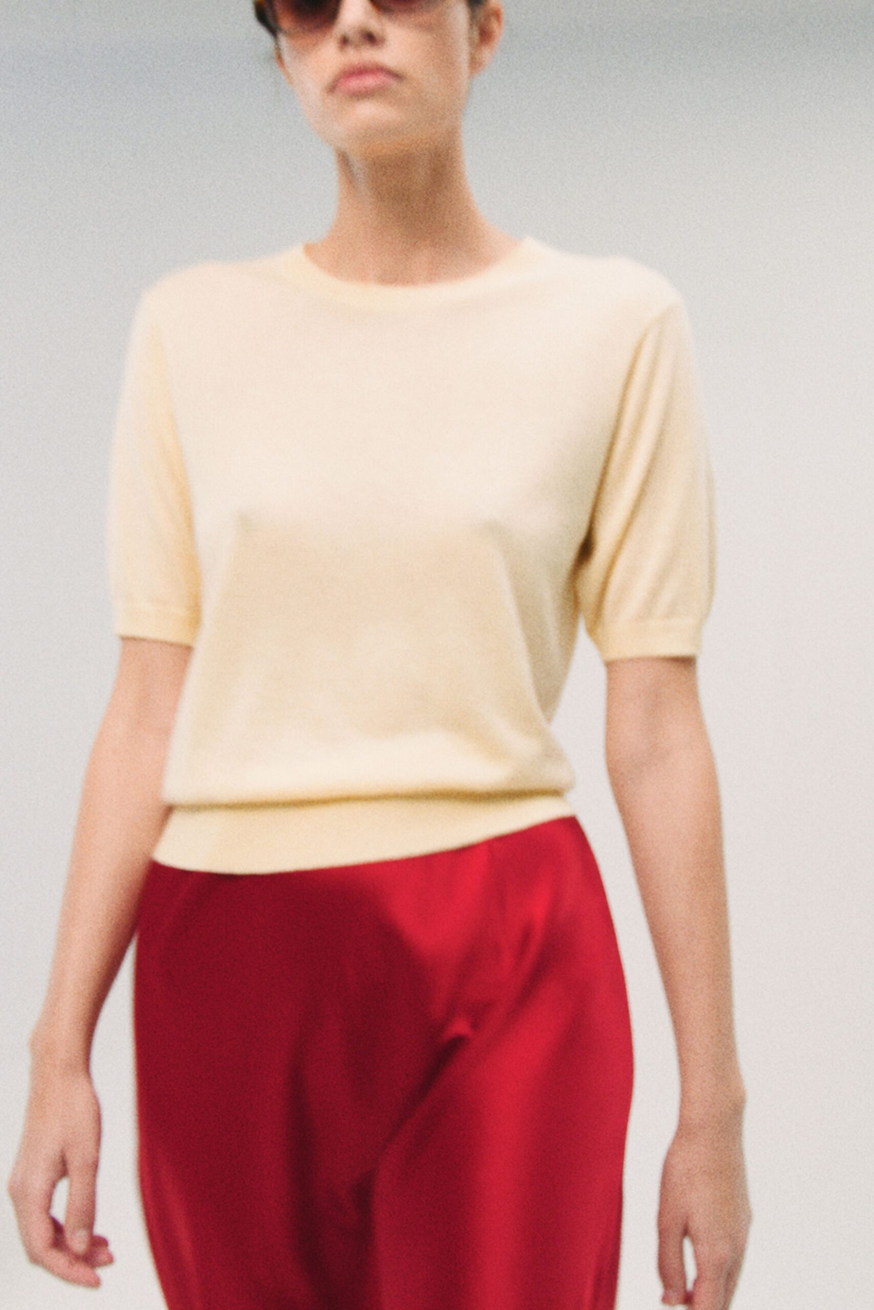 yellow fitted top with red pants