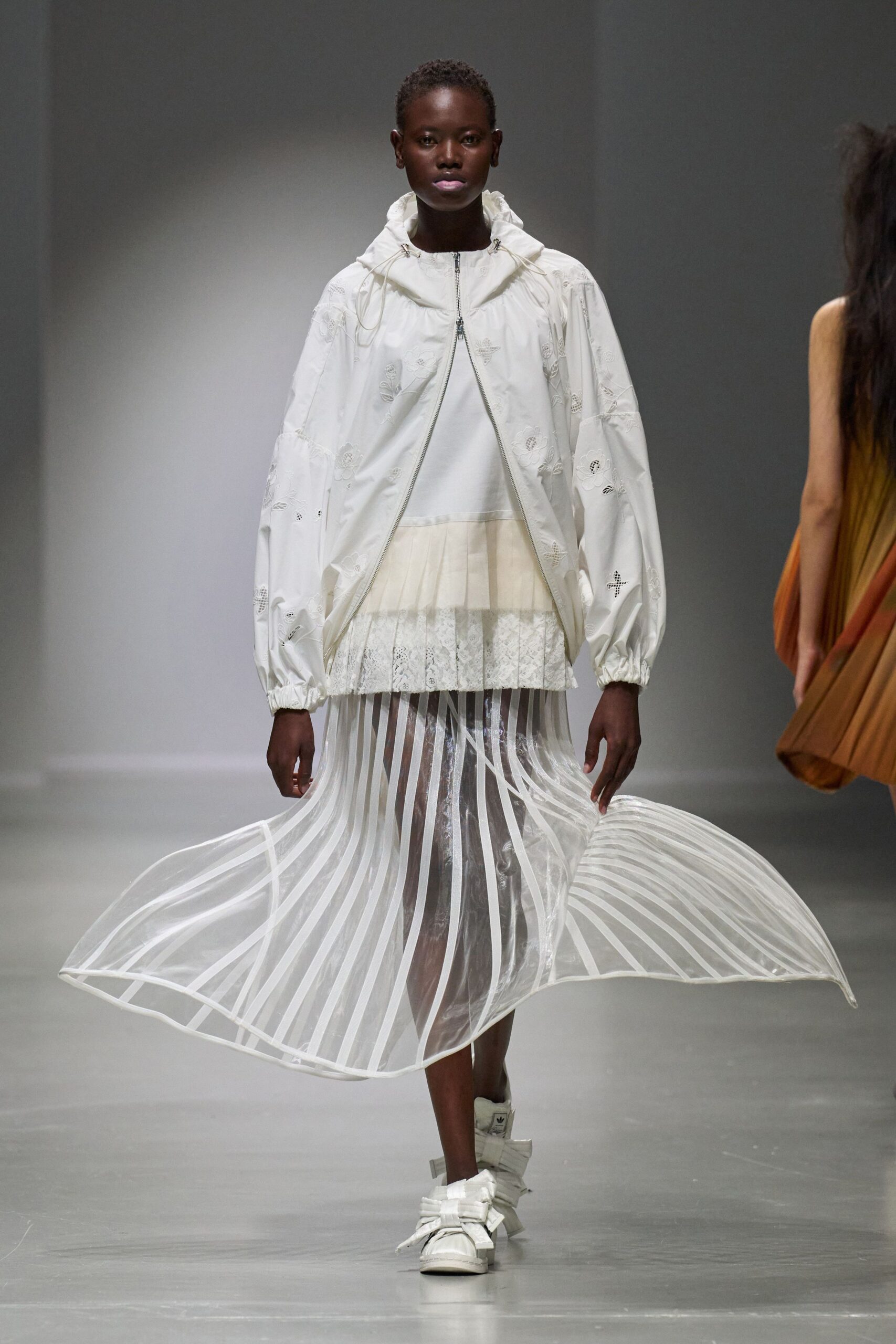 white jacket with pleated skirt
