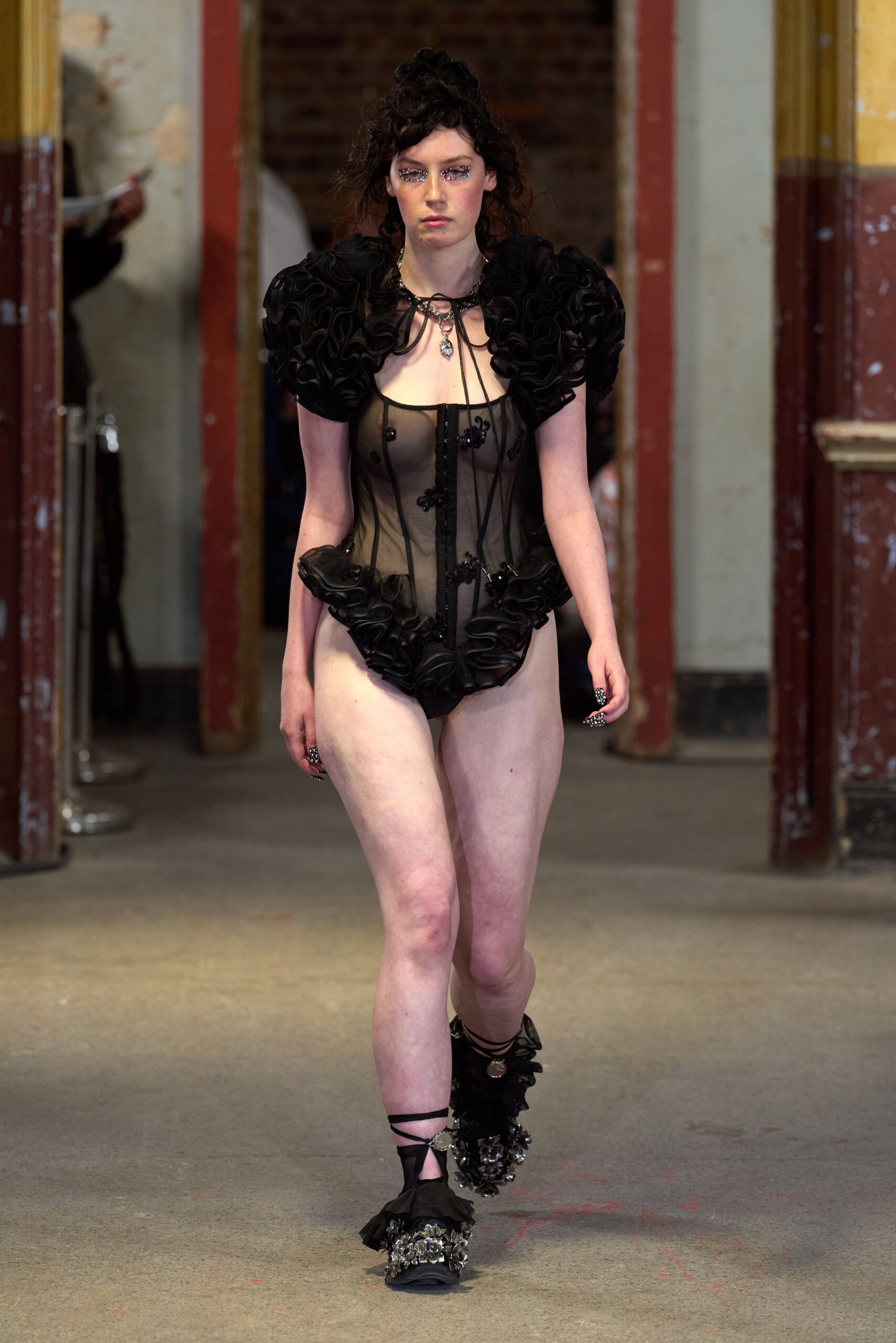 black ruffled bodysuit with embellished shoes