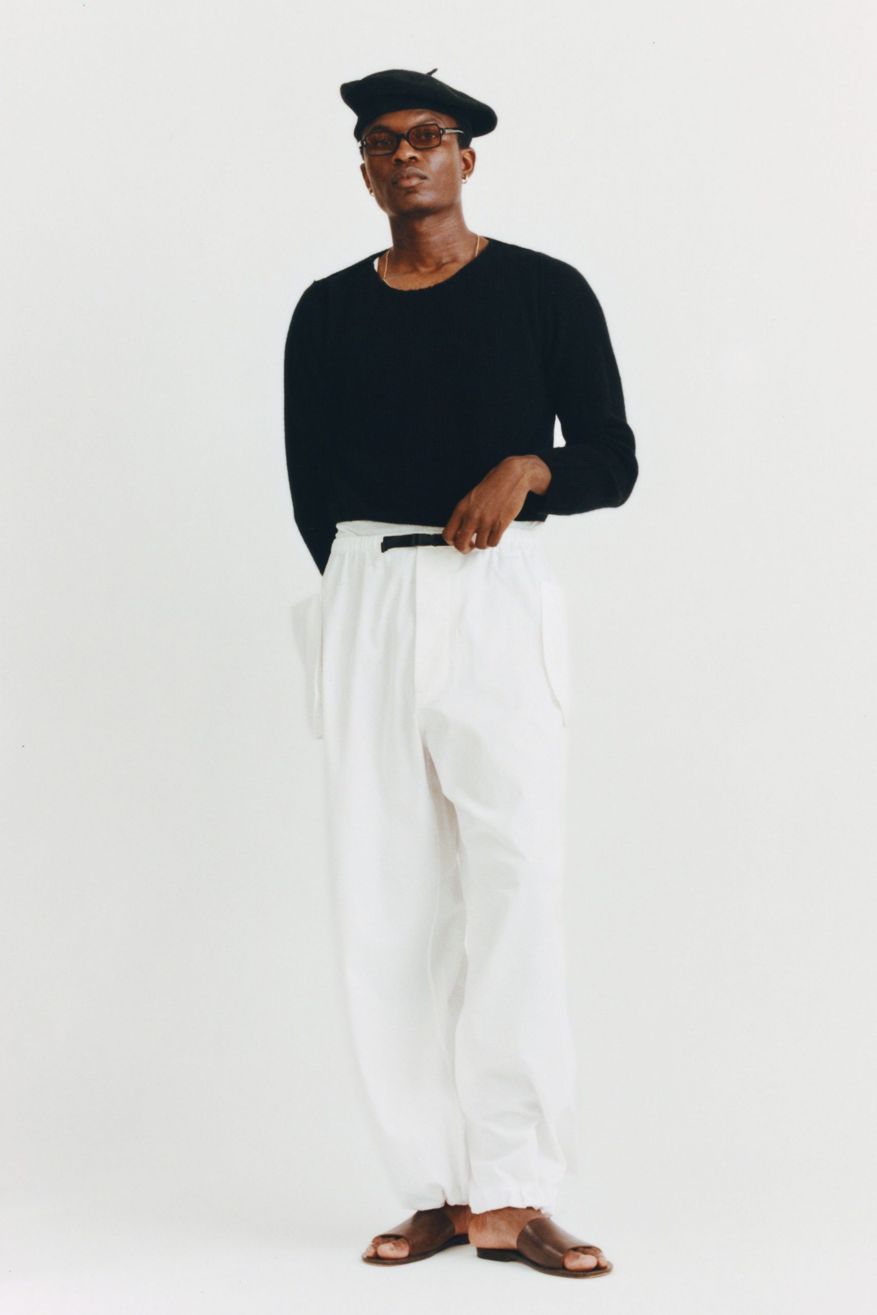 black sweater white pants brown shoes