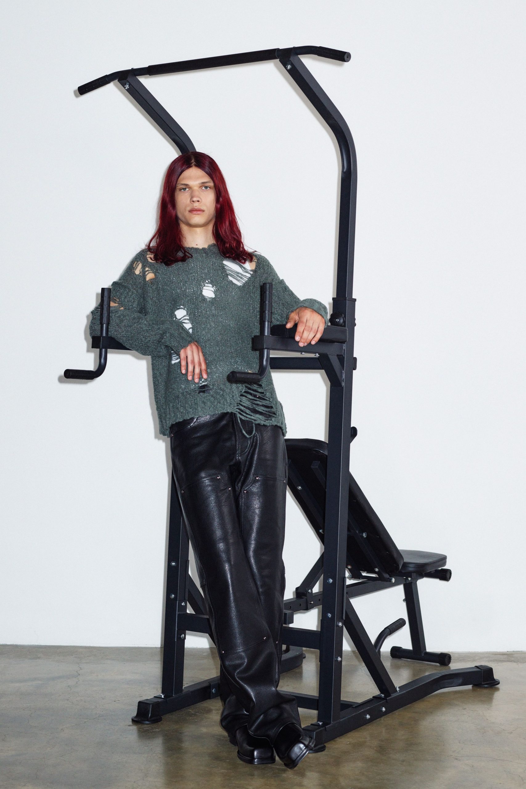 green distressed sweater black leather pants